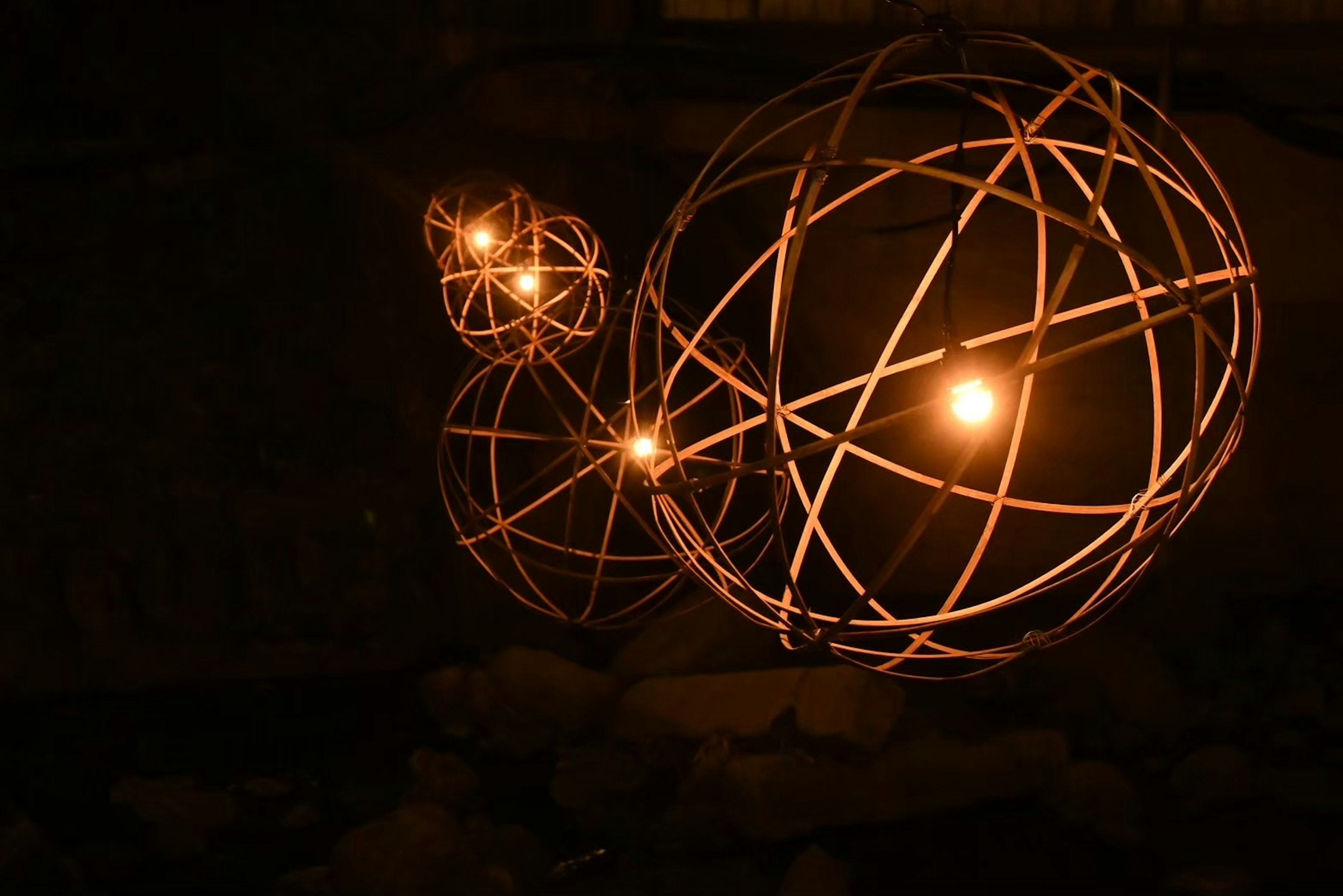 Three glowing spherical objects in a dark background