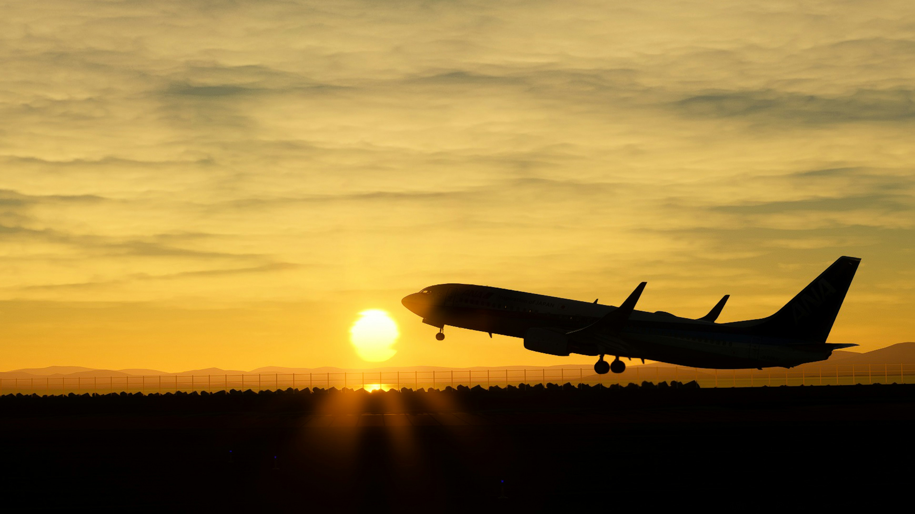 Silhouette of an airplane taking off against a sunset