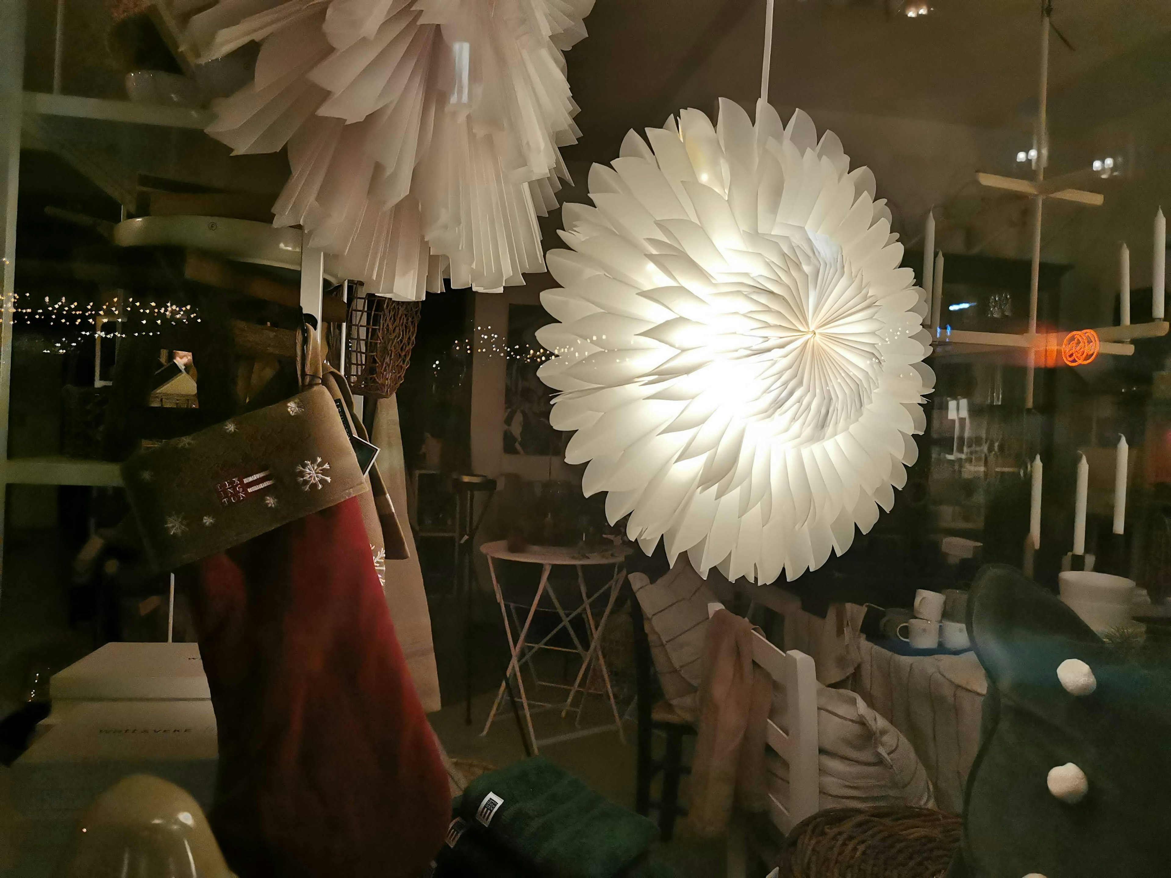 Decorative display inside a shop with a glowing white lamp