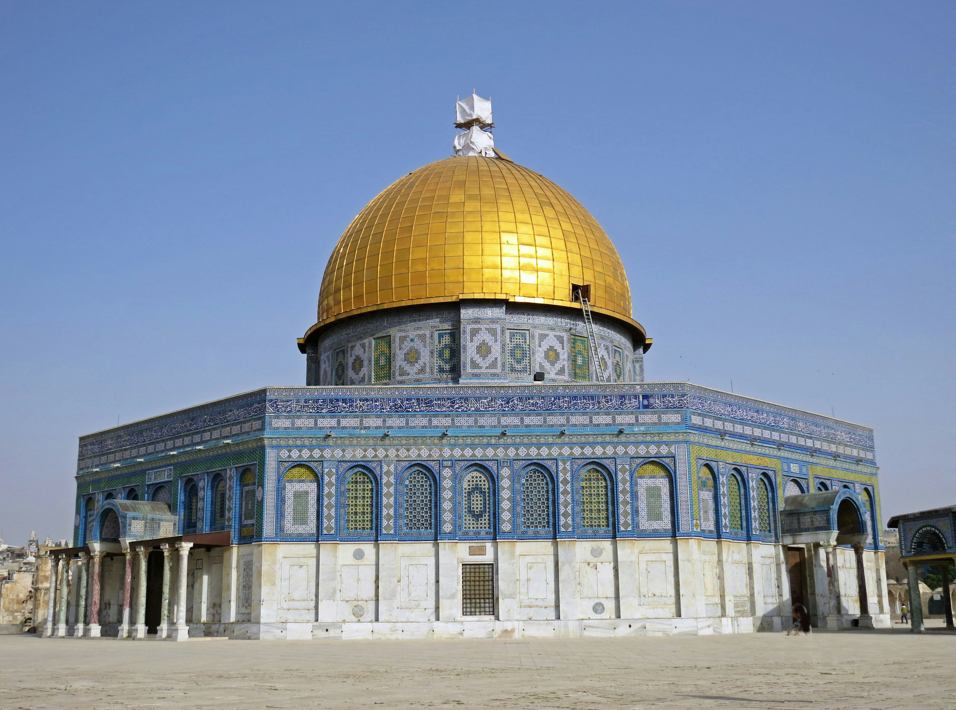 The Dome of the Rock with its golden dome featuring blue tile decorations and ancient architectural style