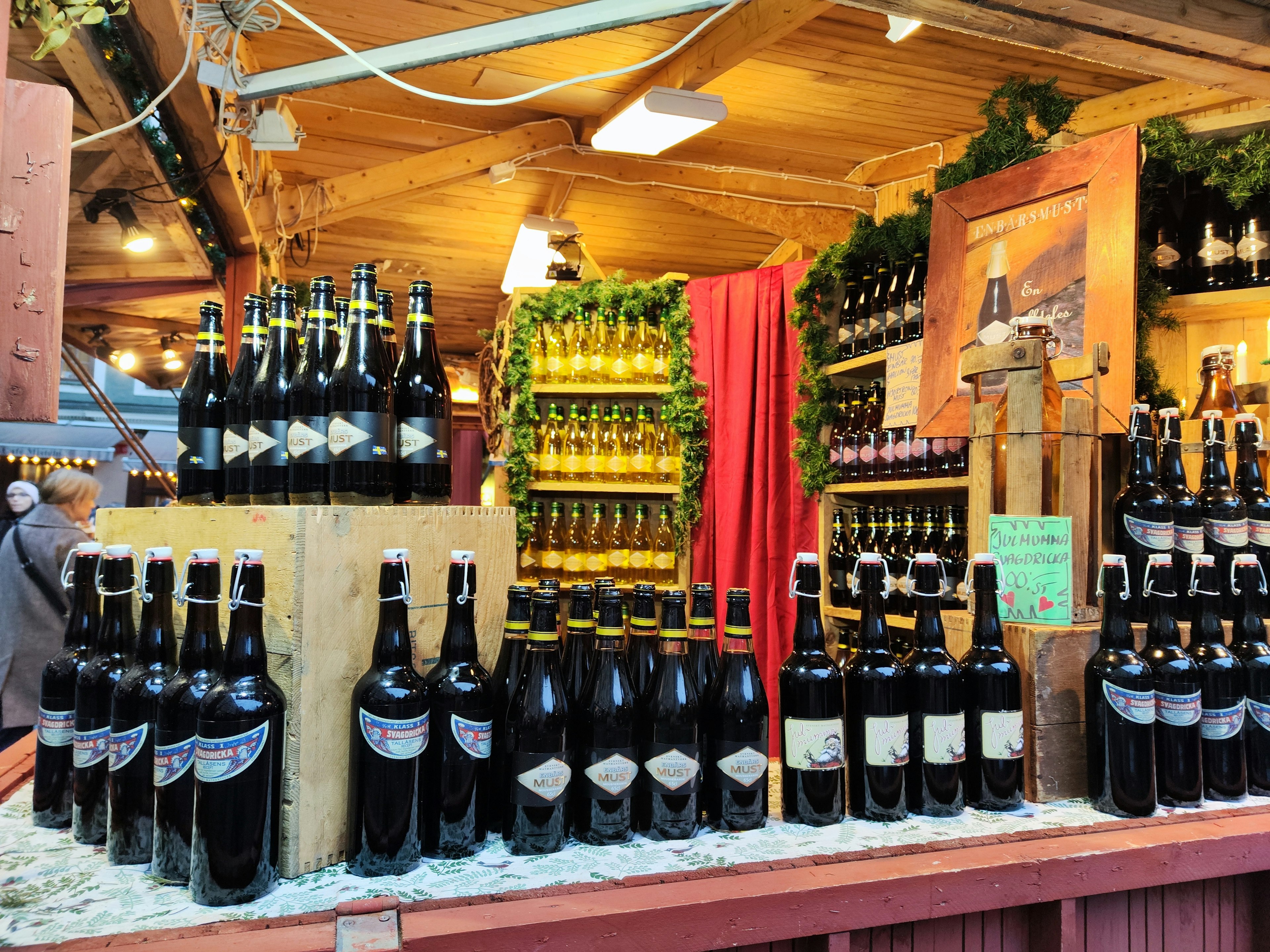 A display of black and gold bottles in a market setting