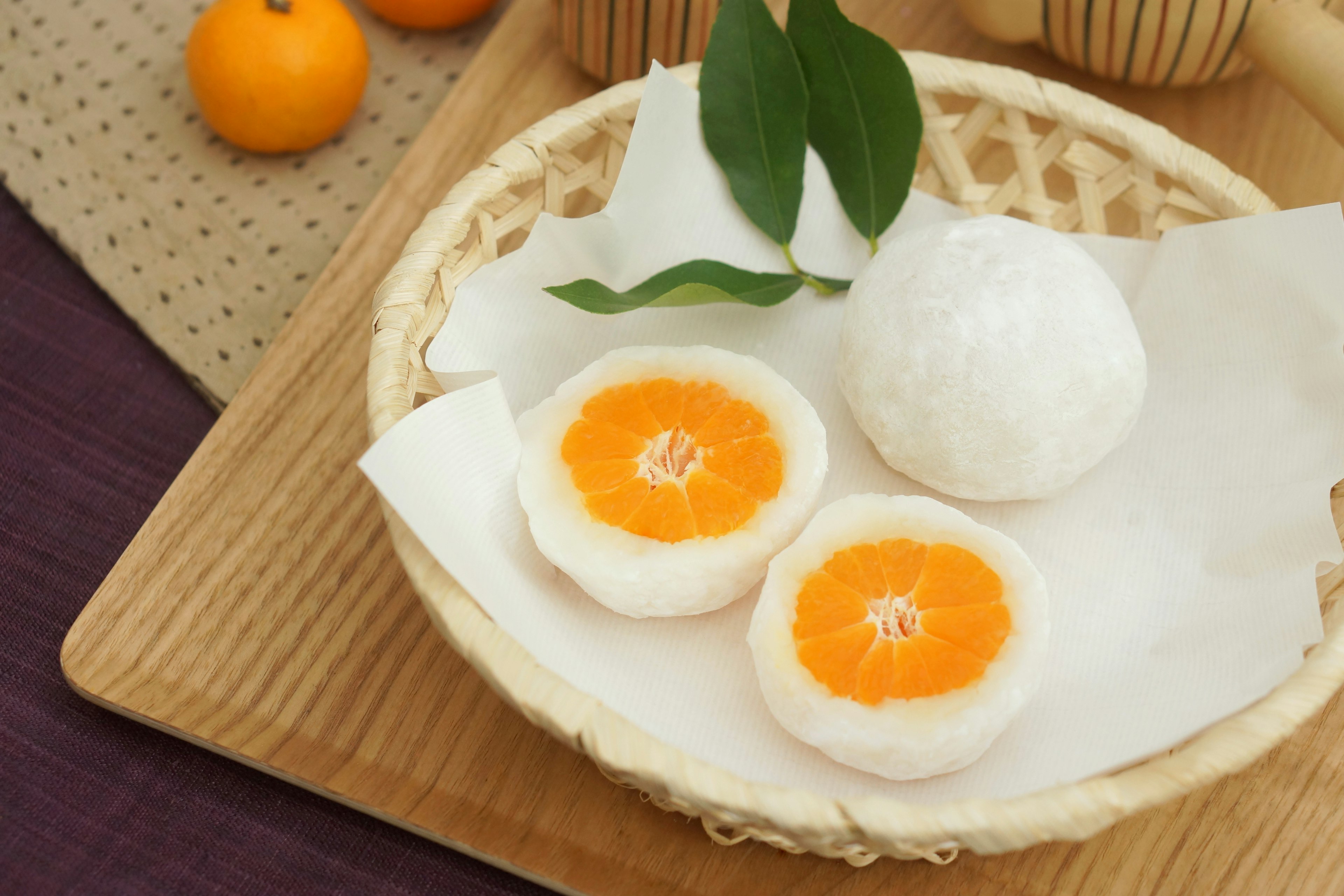 Presentation of Japanese sweets featuring white dumplings and orange filling