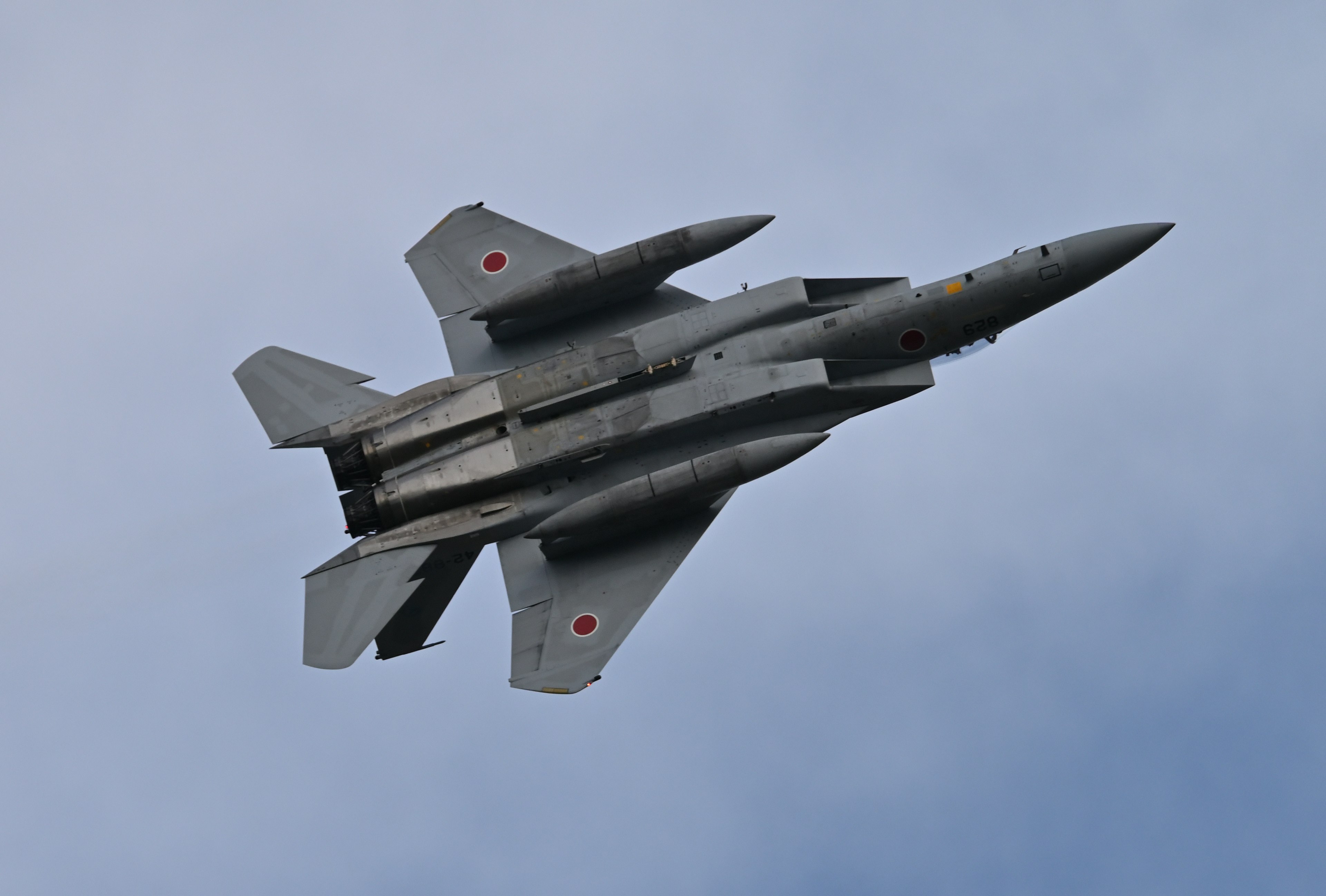 Japanese fighter jet F-15 performing a maneuver in the sky