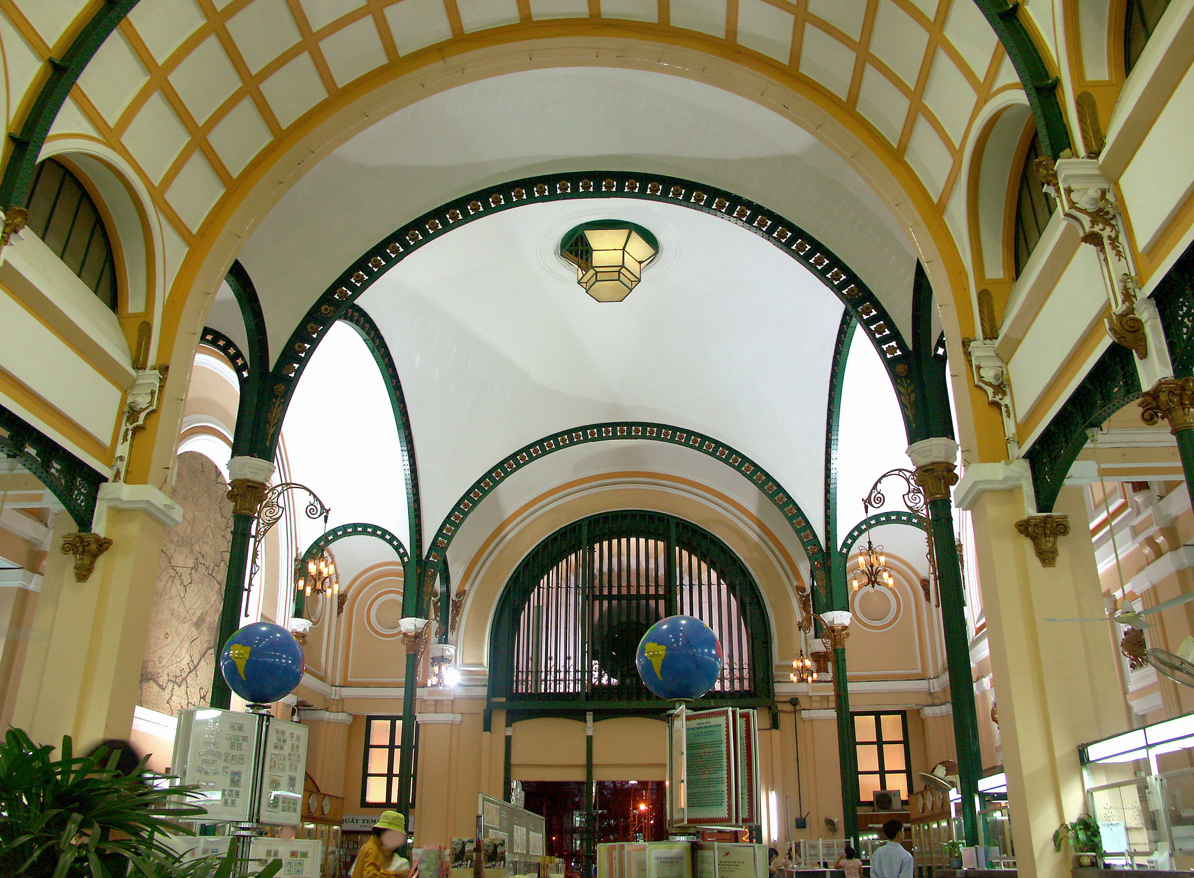 Interior of a building with beautiful arched ceiling and green decorations featuring globes