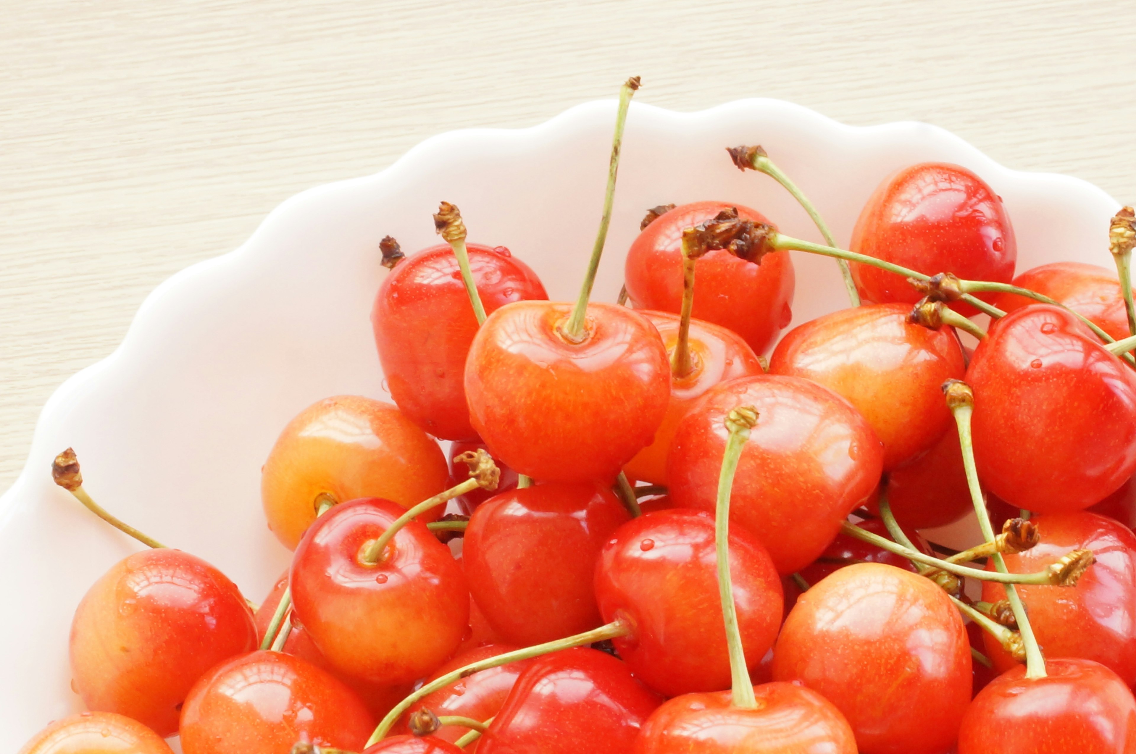 Close-up of red cherries in a white bowl