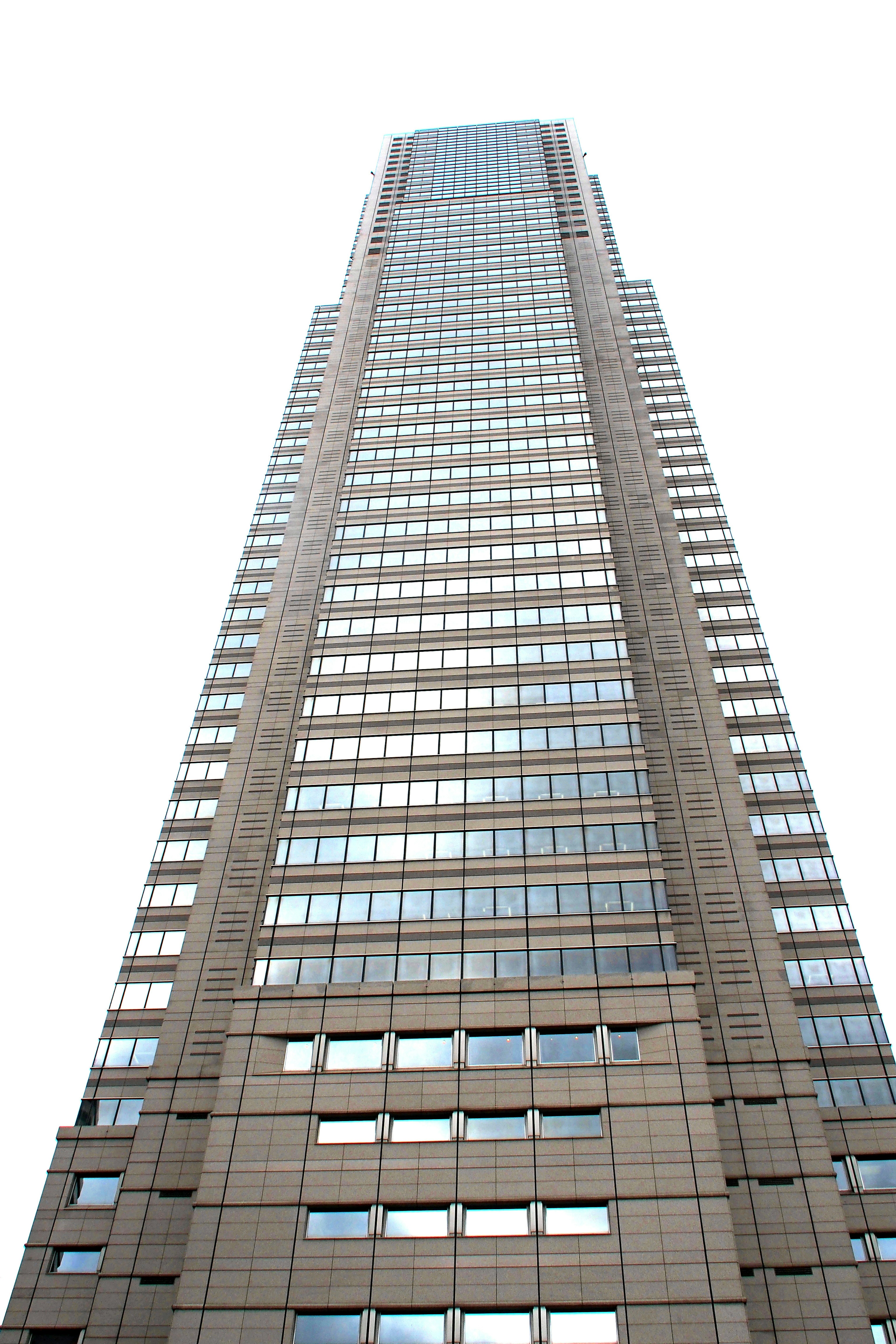 Vertical view of a skyscraper with reflective glass windows