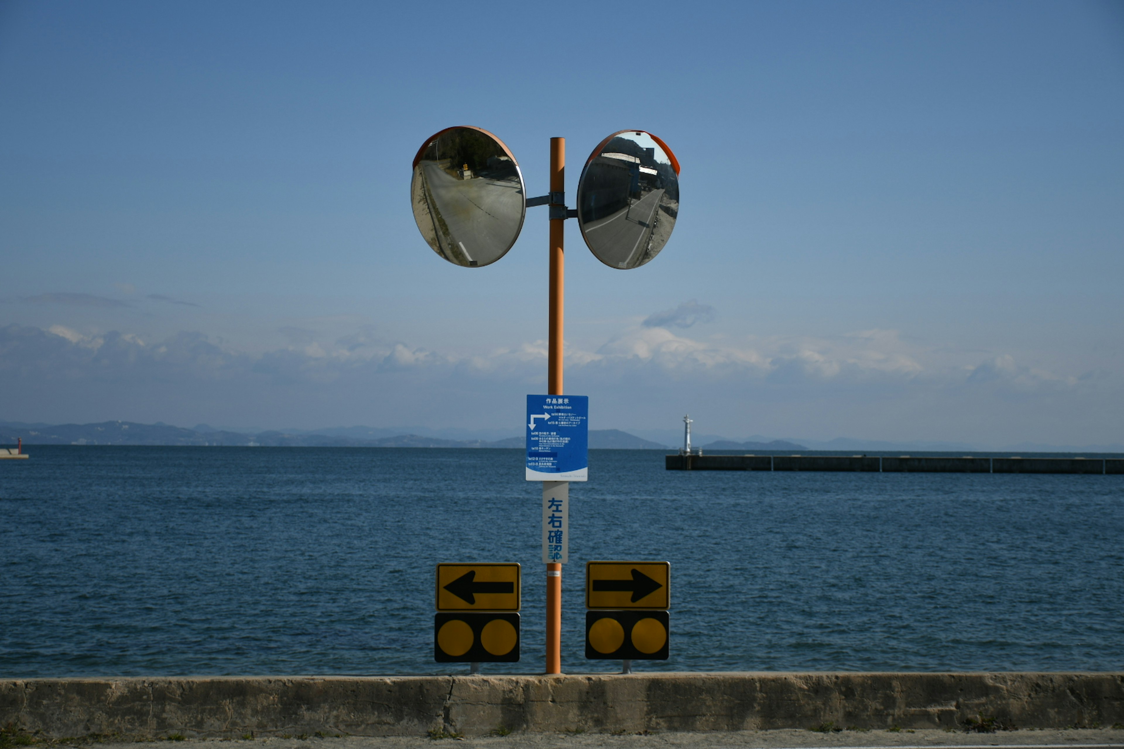 Seaside view featuring mirrors and directional signs