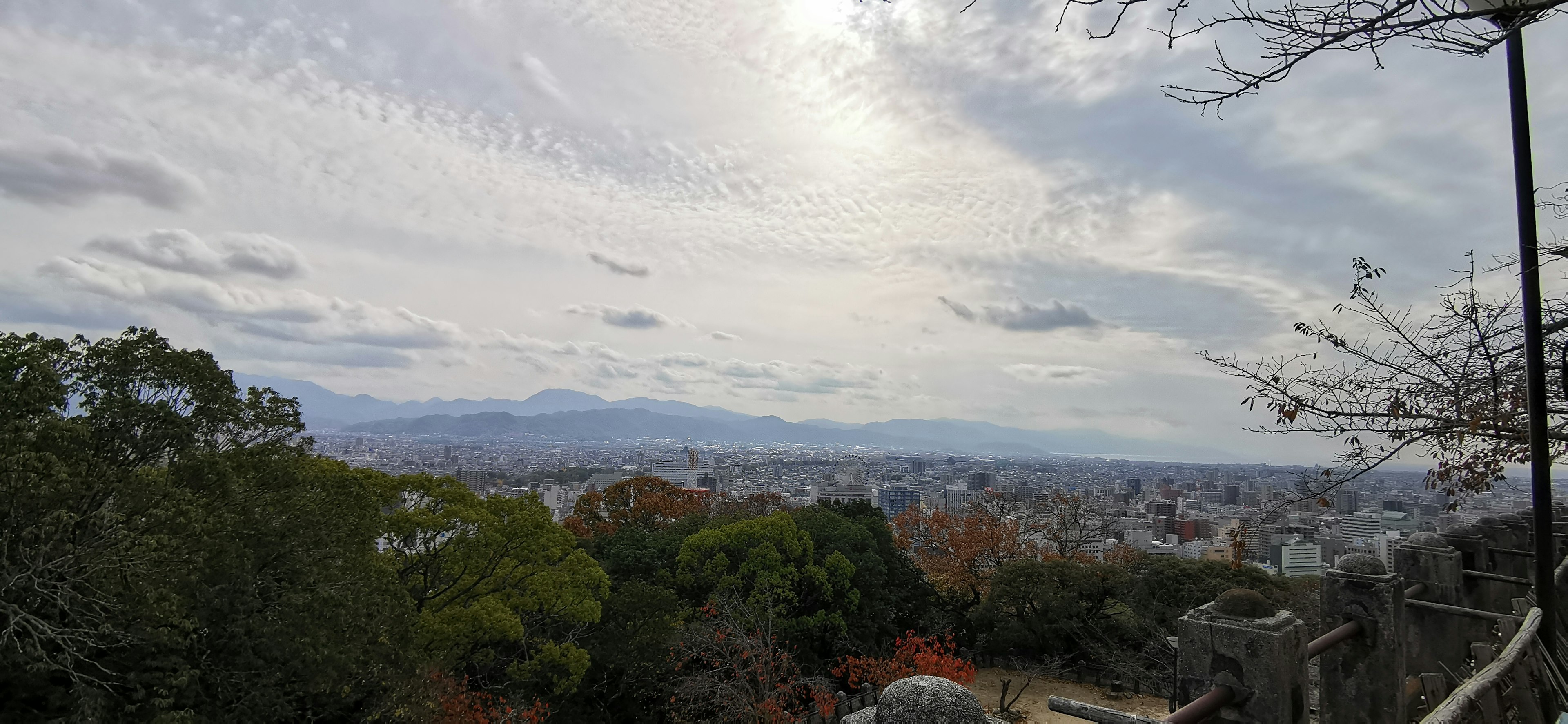 Panoramablick auf Berge und Stadt mit bunten Bäumen