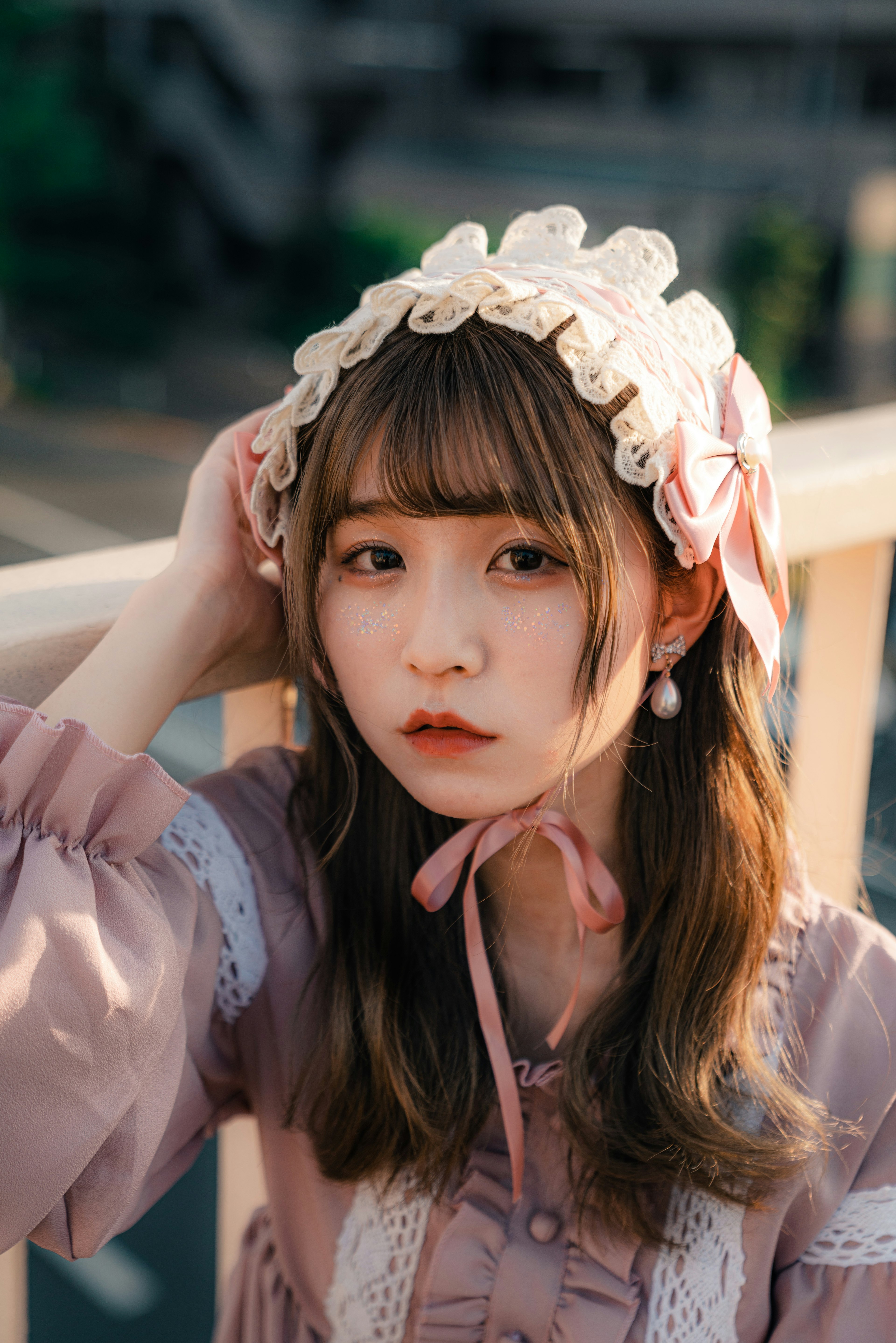 Young girl wearing a pink dress and a white lace headband