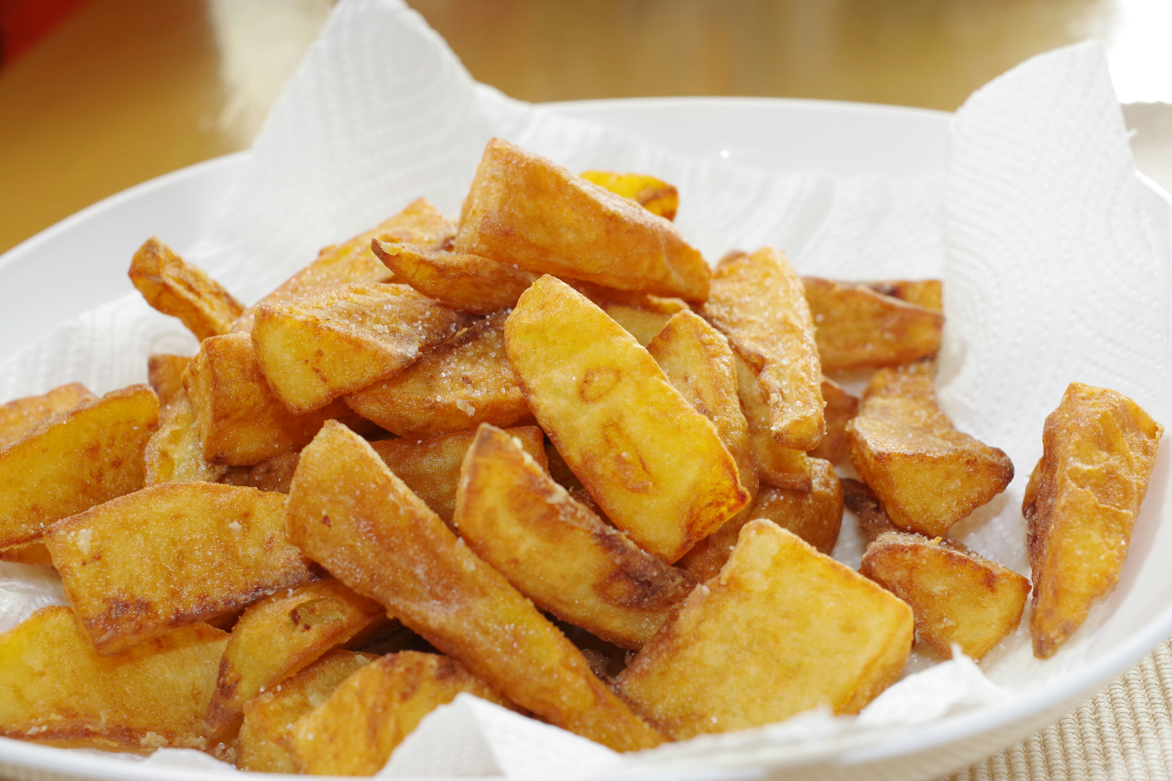 A plate of golden brown fried potato wedges