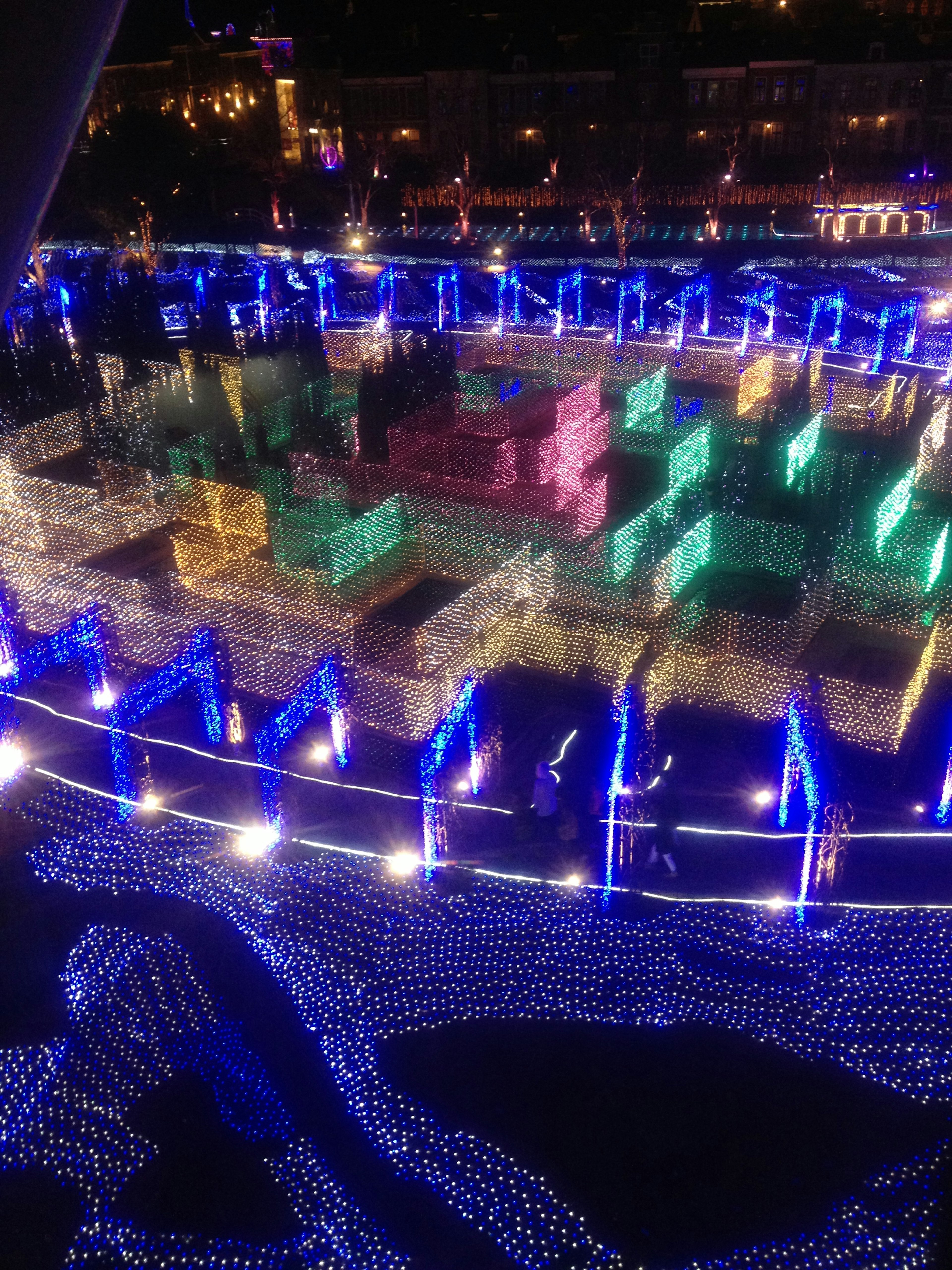 Colorful light installation reflecting on water at night