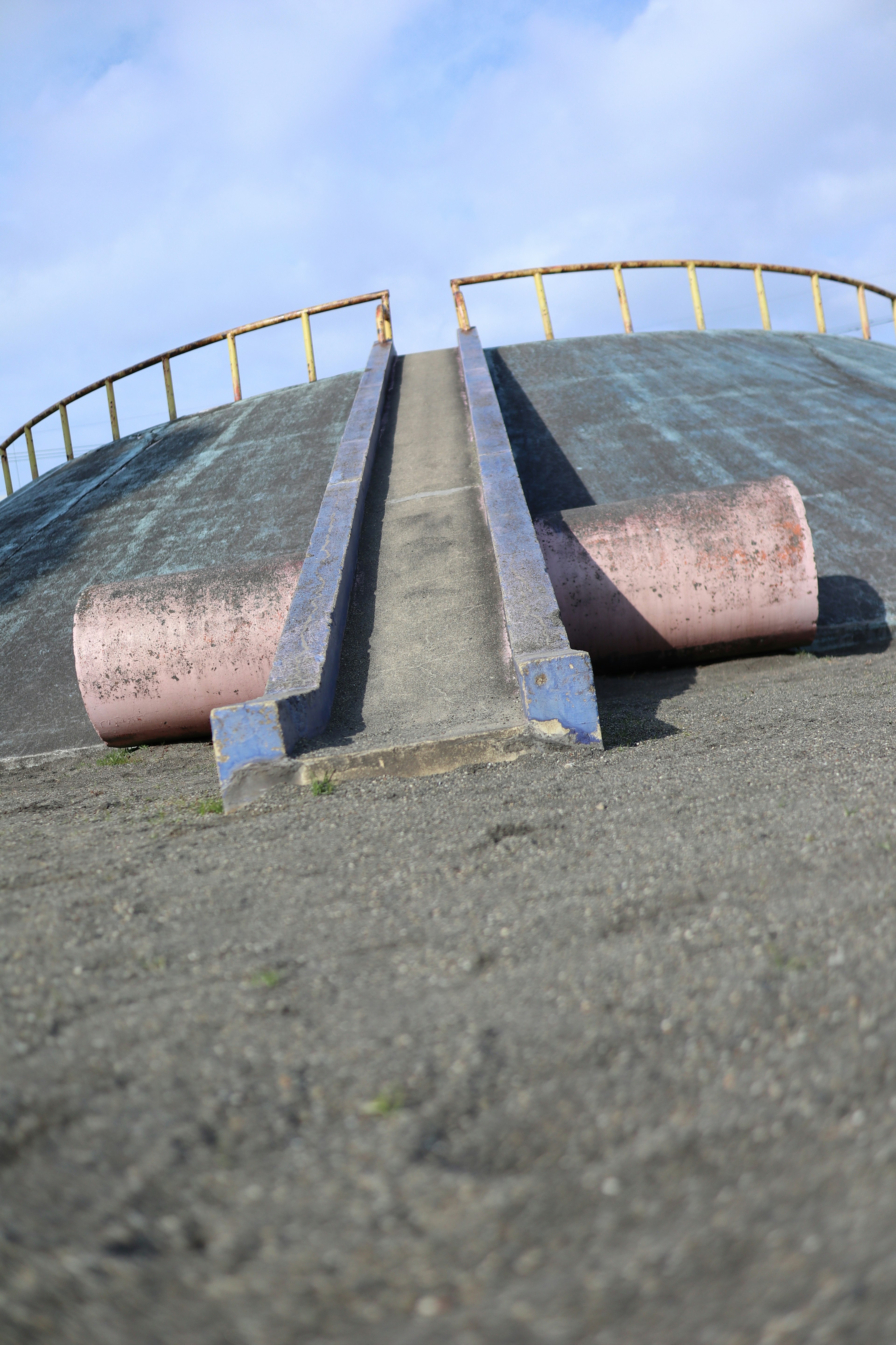 Playground equipment with a slide under a blue sky