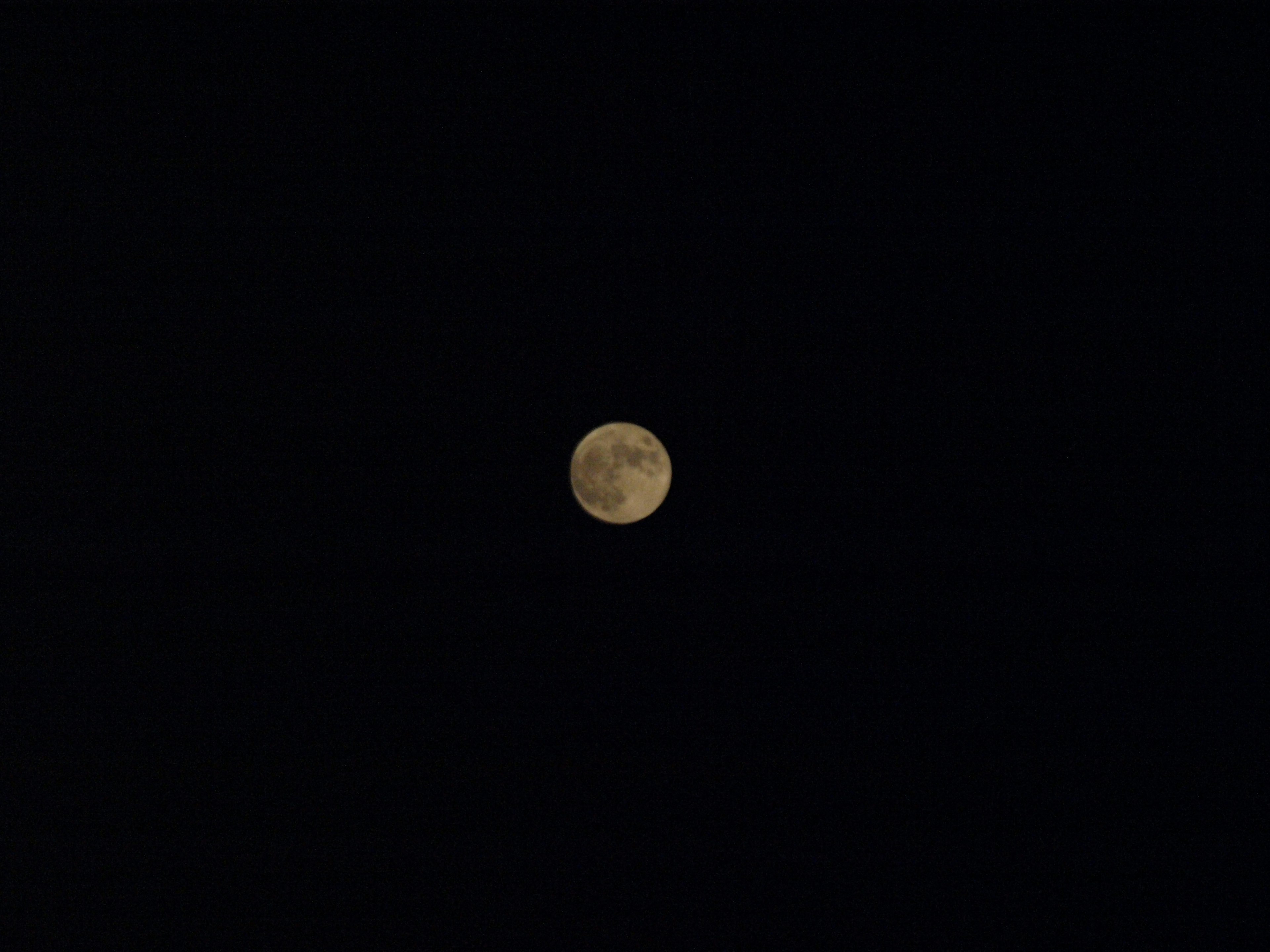 Bright full moon in the night sky