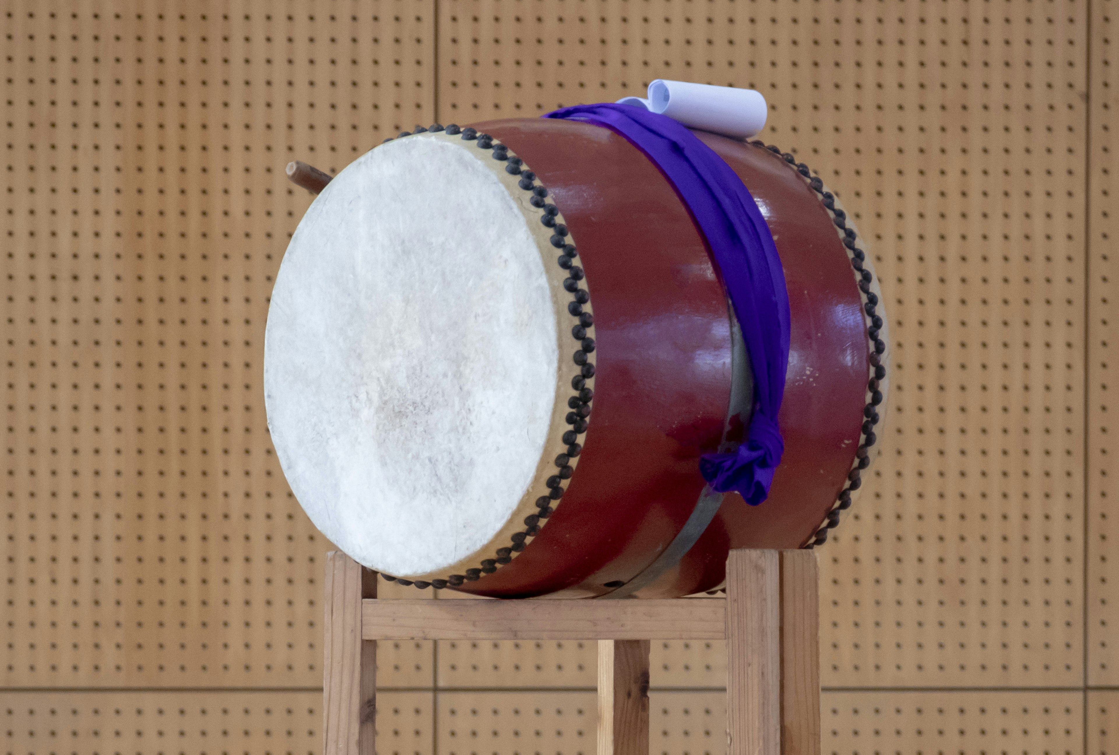 A large traditional taiko drum placed on a wooden stand