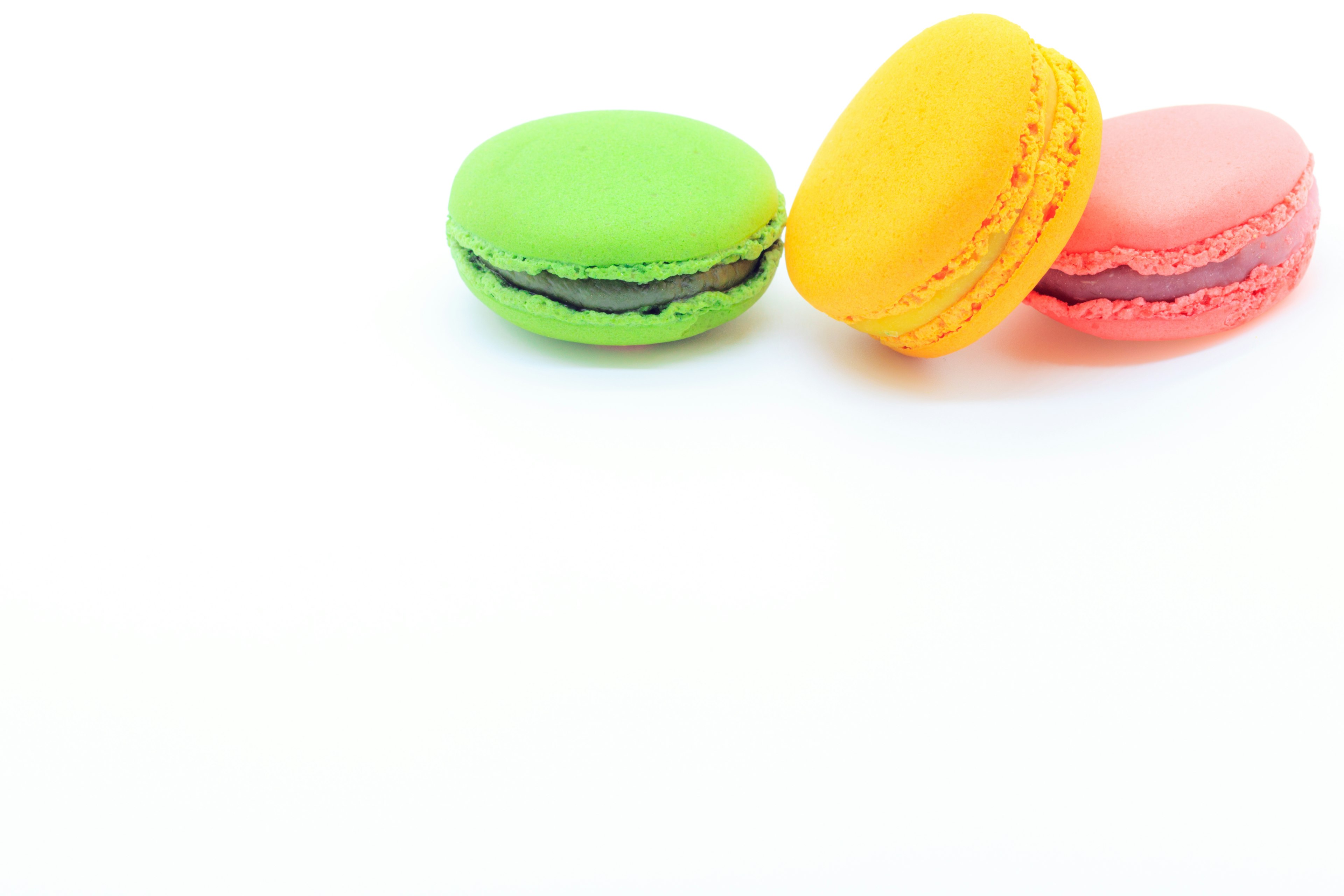 Colorful macarons arranged on a white background