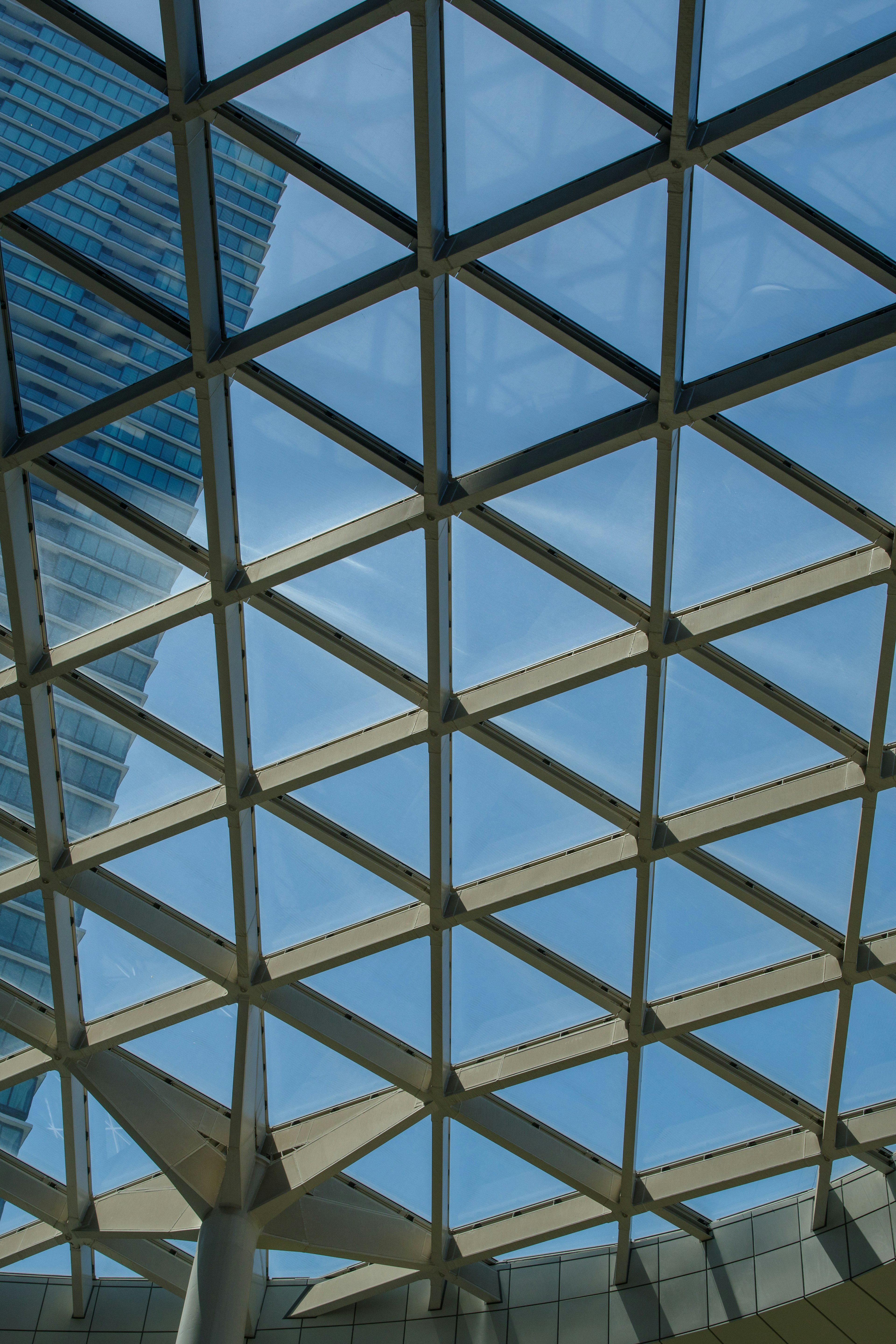 Geometric glass ceiling with blue sky view