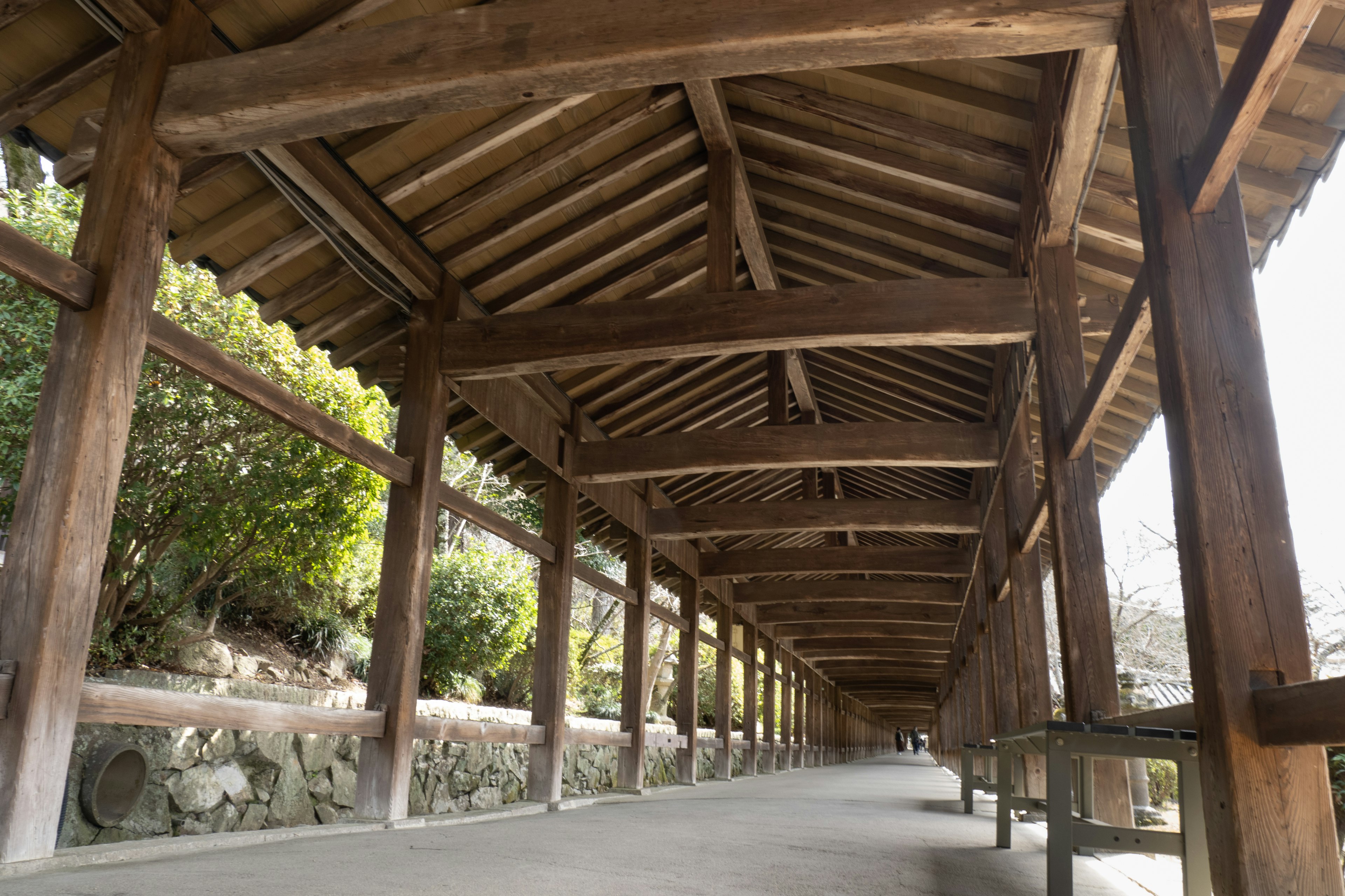 Interior view of a wooden arcade with a sloping roof