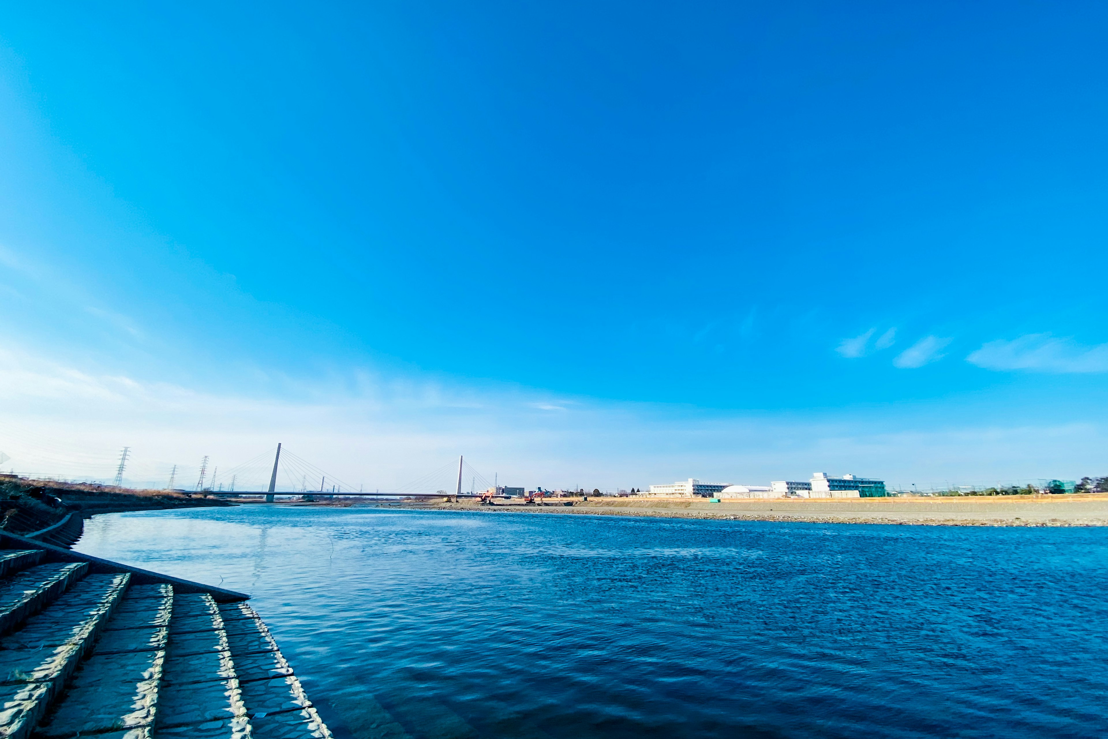 Scenic view of a river under a clear blue sky