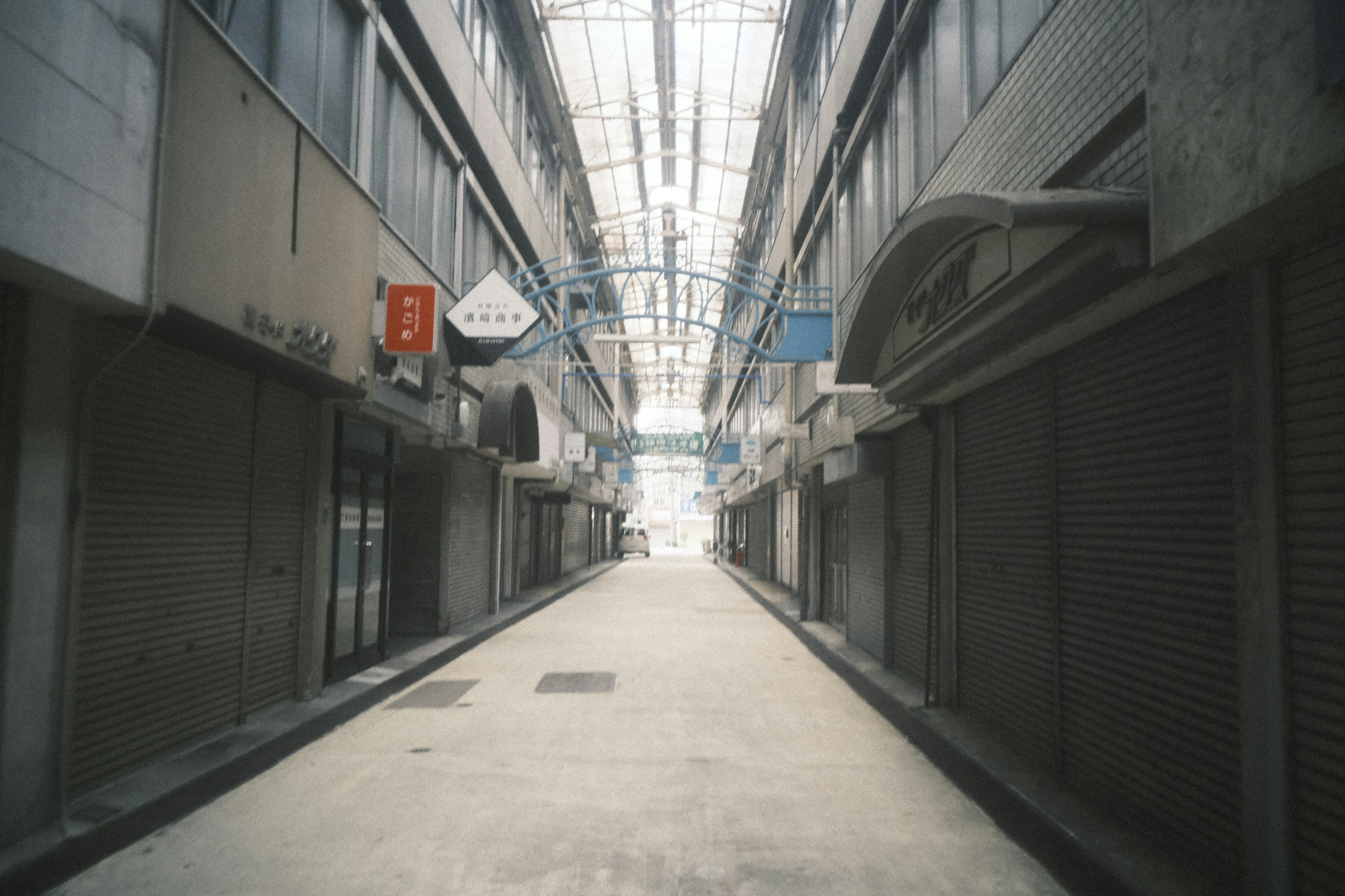 Rue vide avec des magasins fermés et un toit transparent