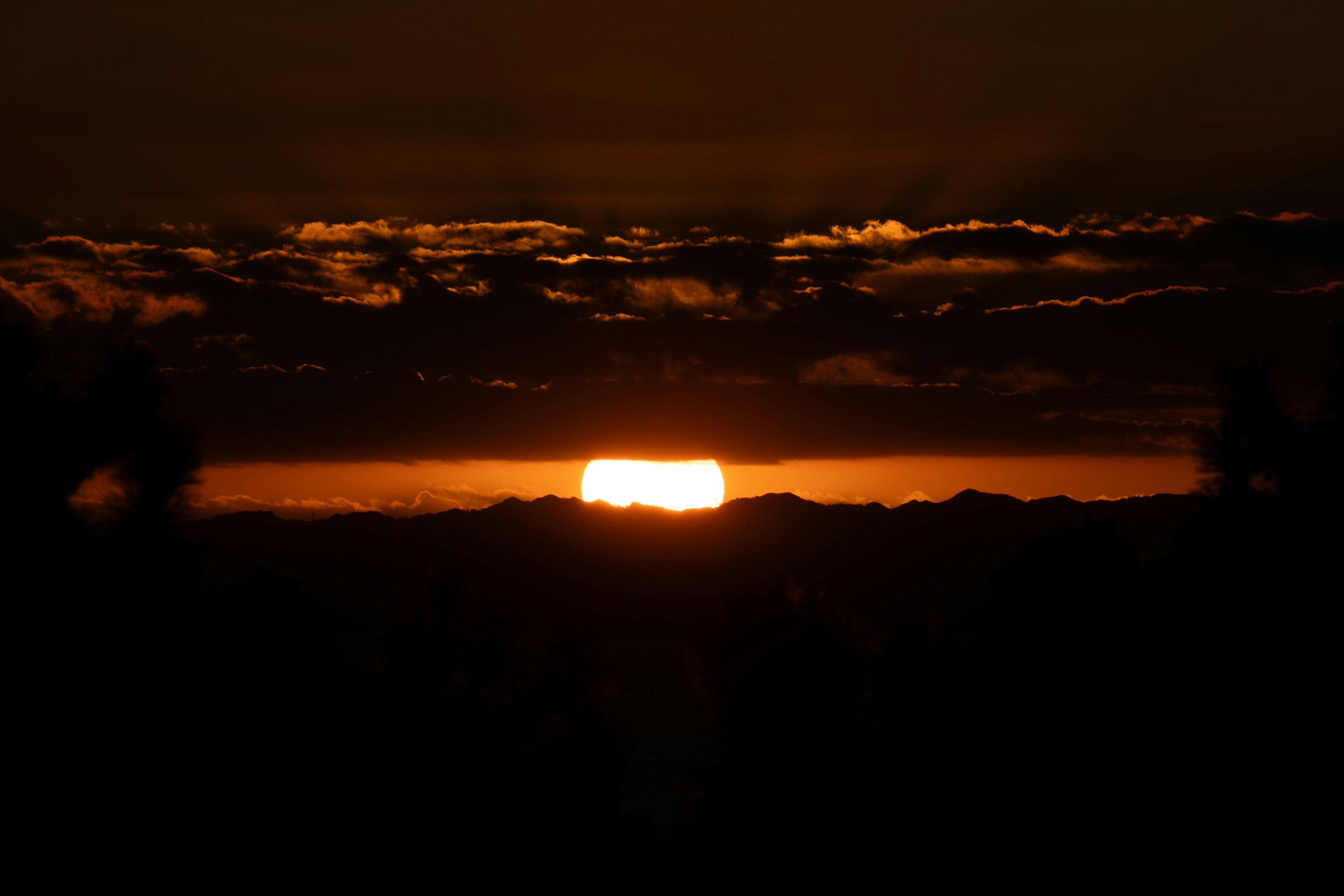 夕日が山の間から昇る美しい風景