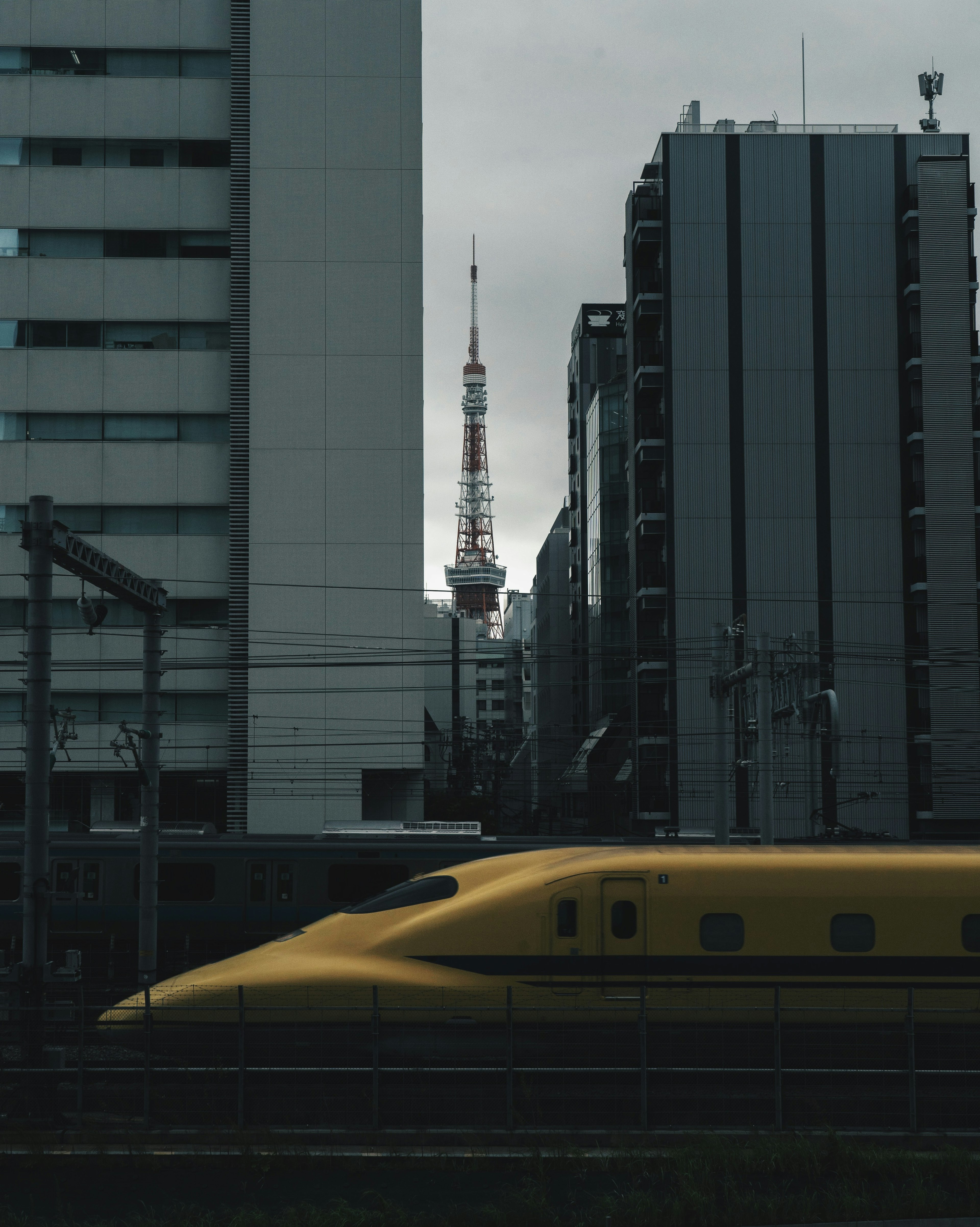 Städtische Szene mit dem Tokyo Tower und einem gelben Shinkansen