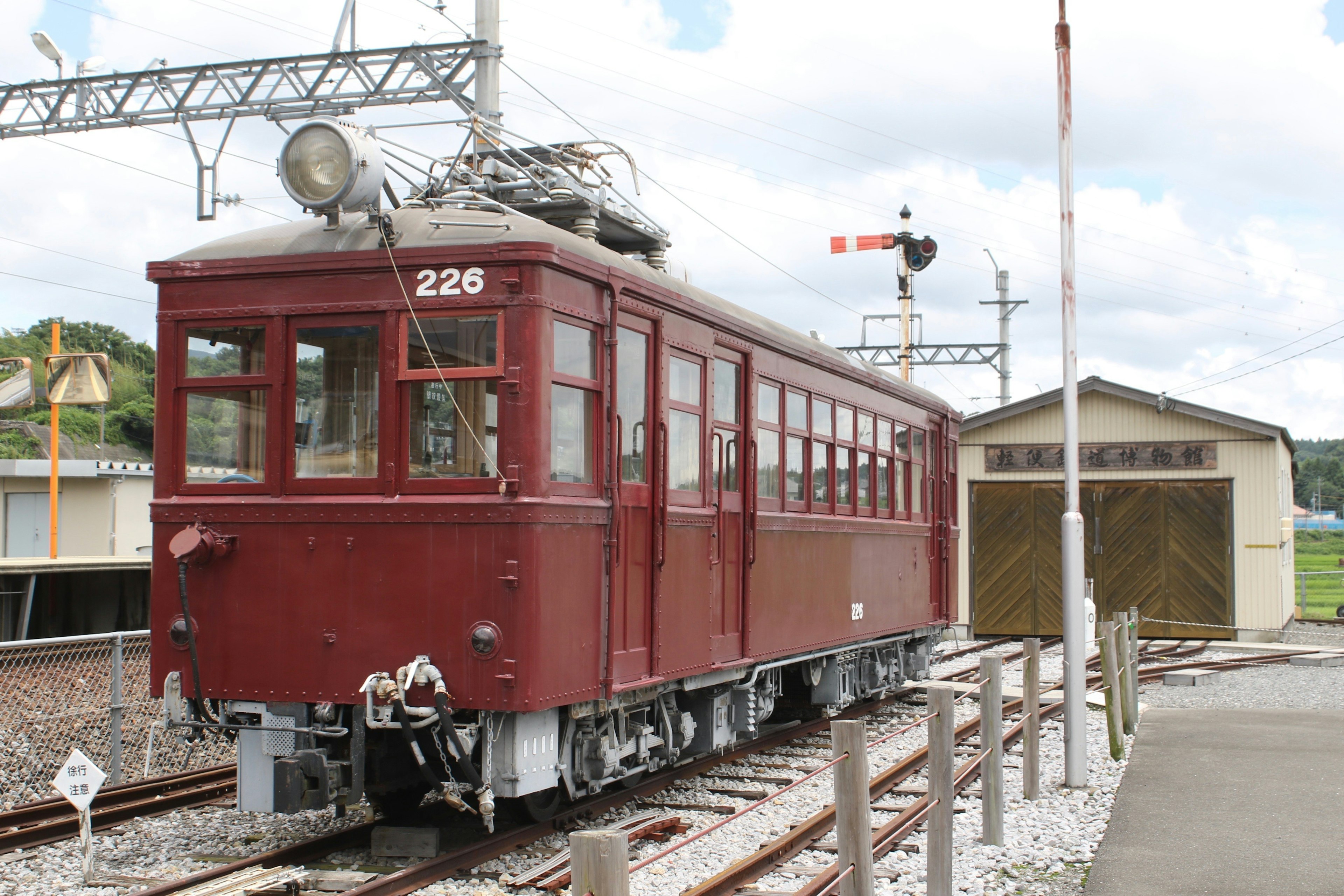 A vintage red train parked at a station