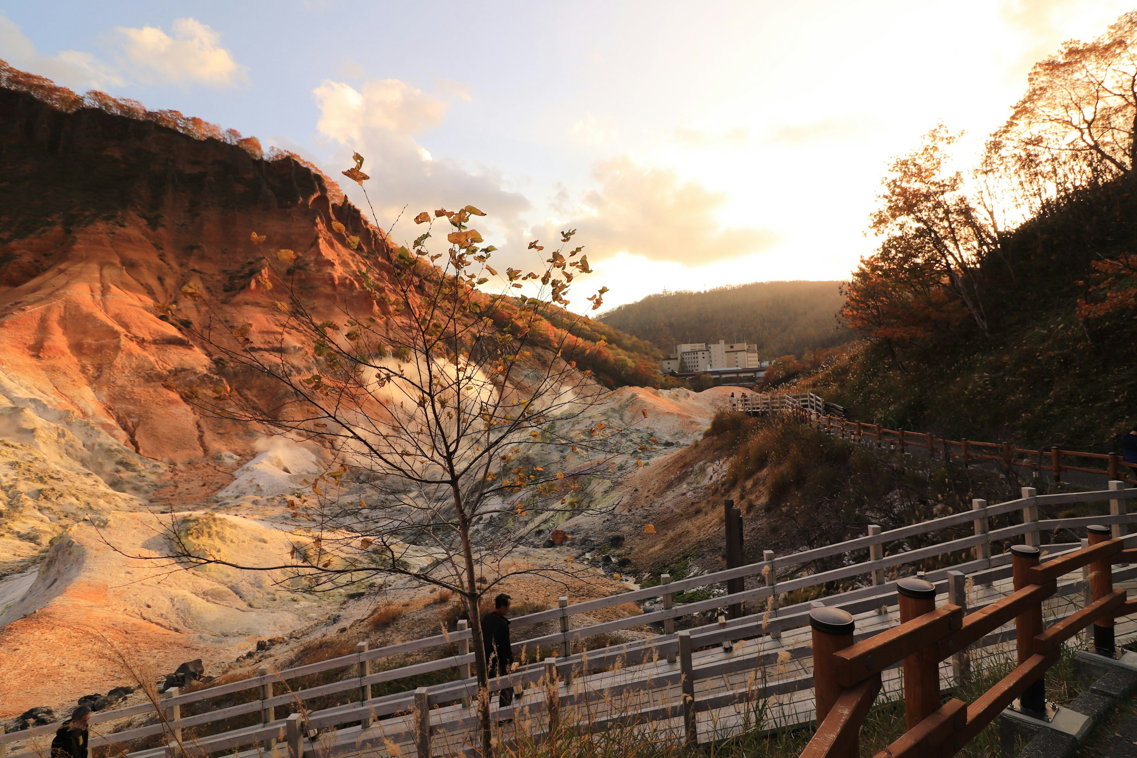 Colorful rock formations illuminated by sunset with wooden walkway