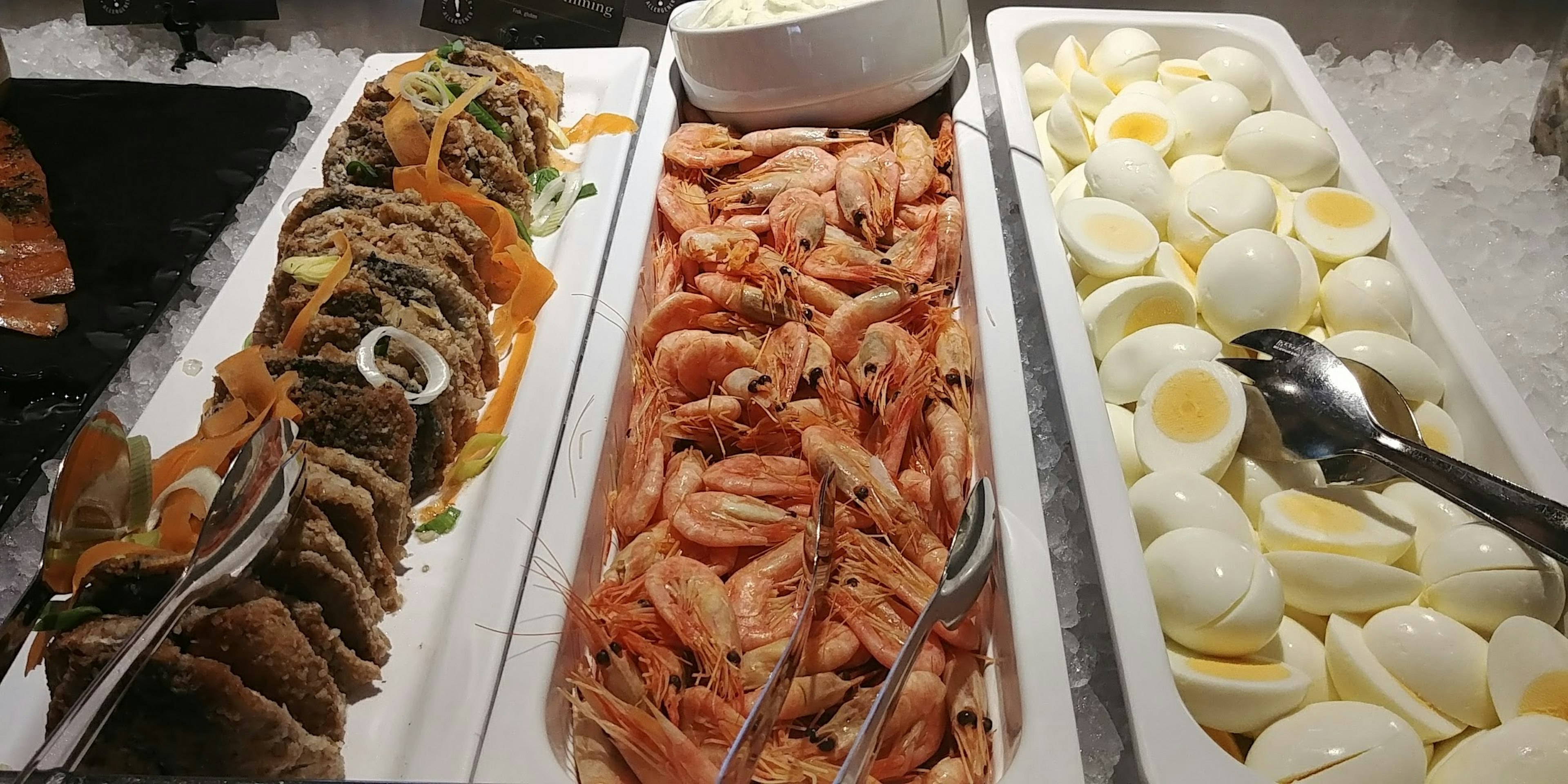 Buffet display featuring shrimp, seafood, and boiled eggs