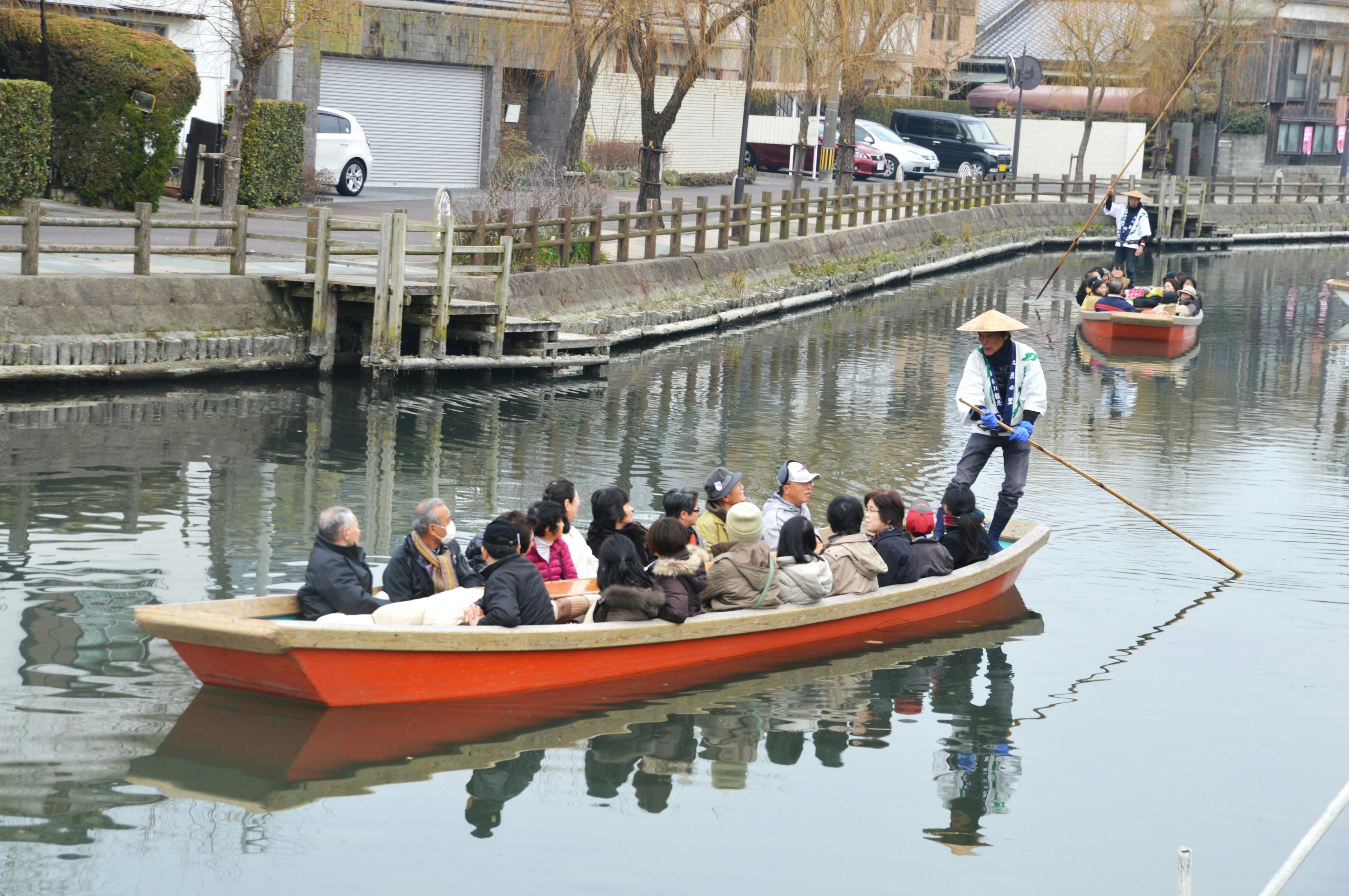 Tourist boat with passengers navigating a calm canal