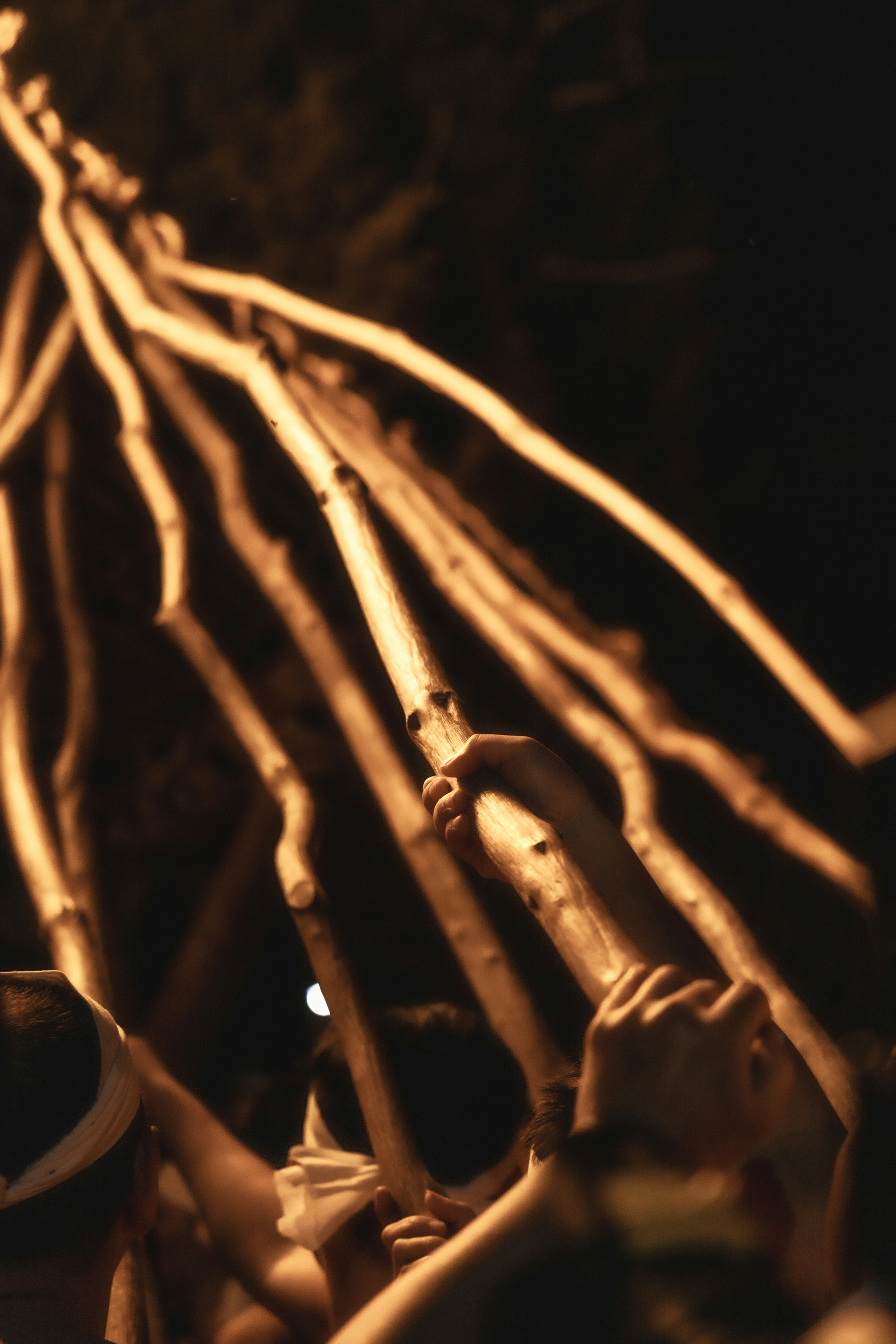 Overlapping wooden sticks against a dark background