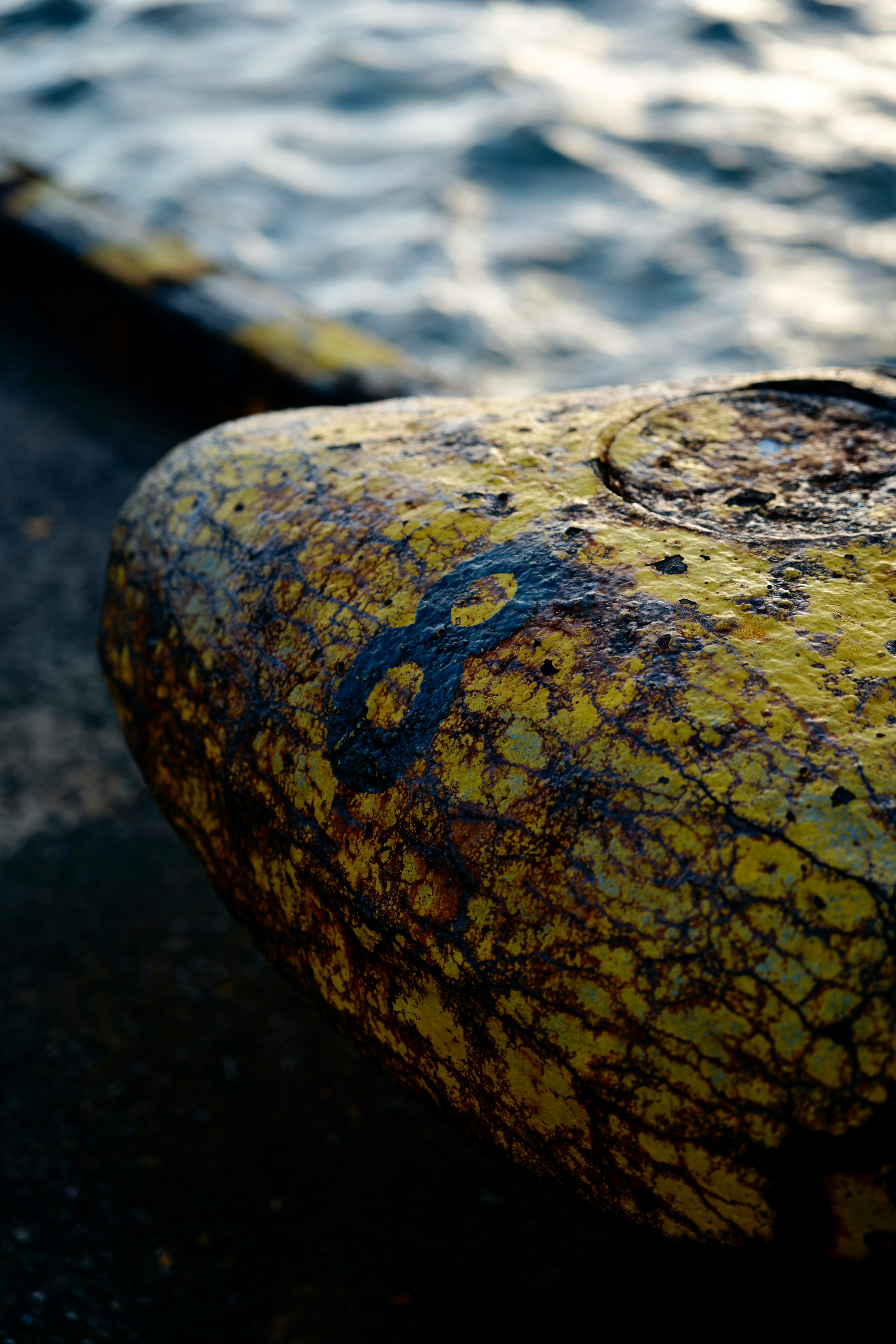 Yellow buoy with blue number 8 near water surface