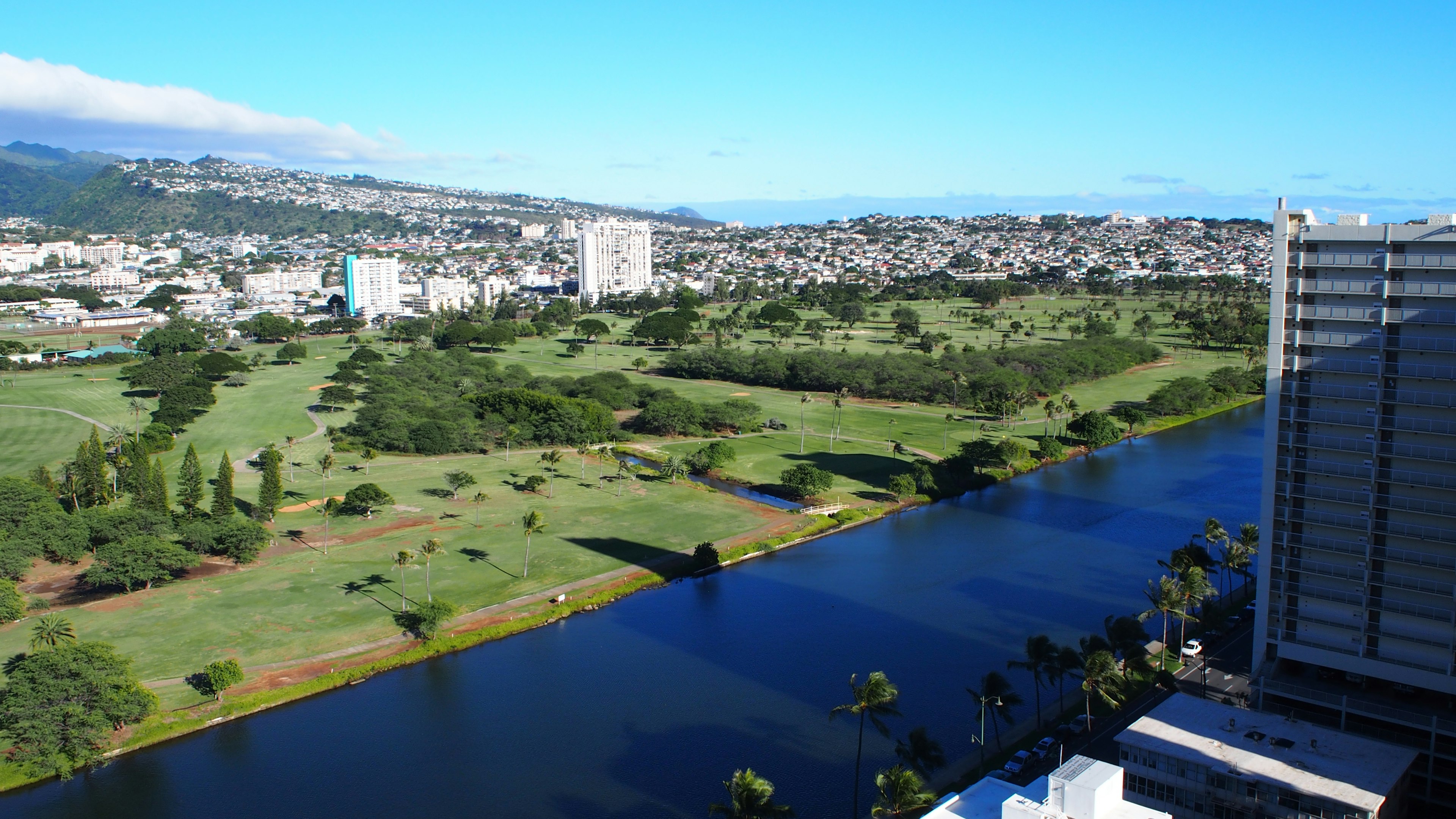 View of a river and green landscape from a high-rise building