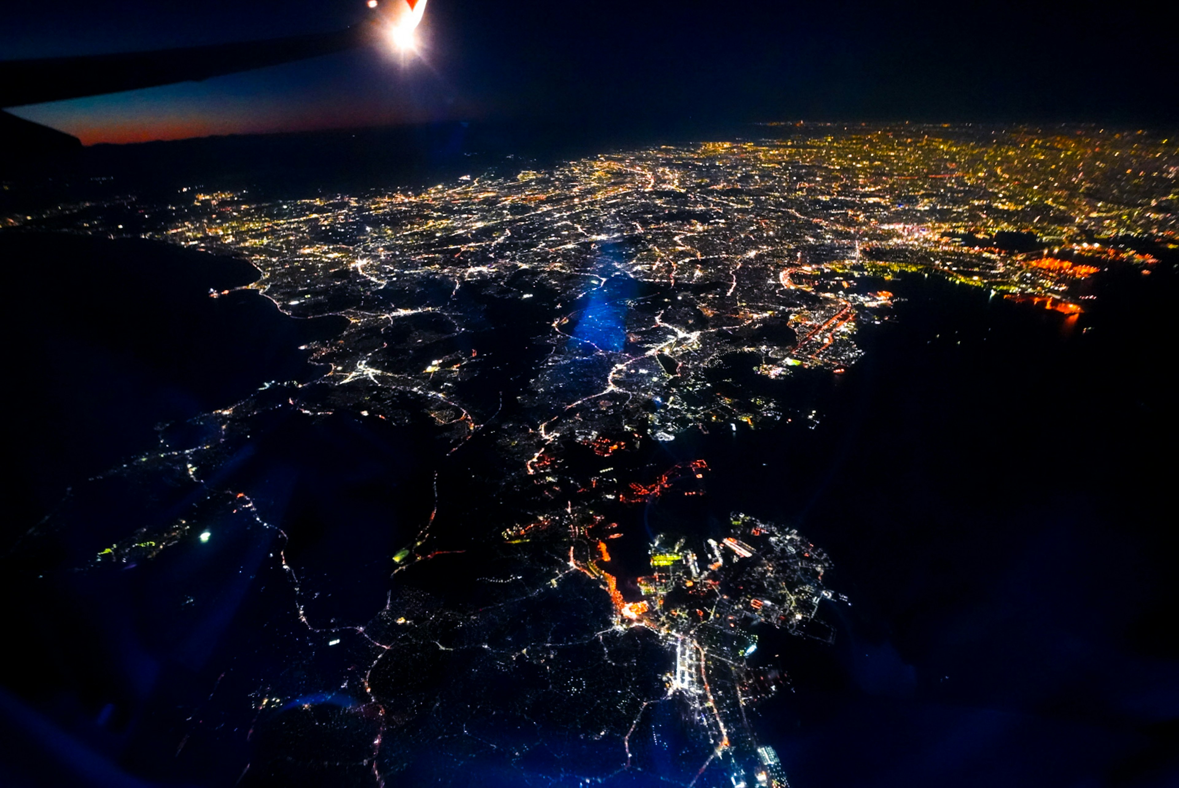 Aerial night view of a city illuminated with bright lights