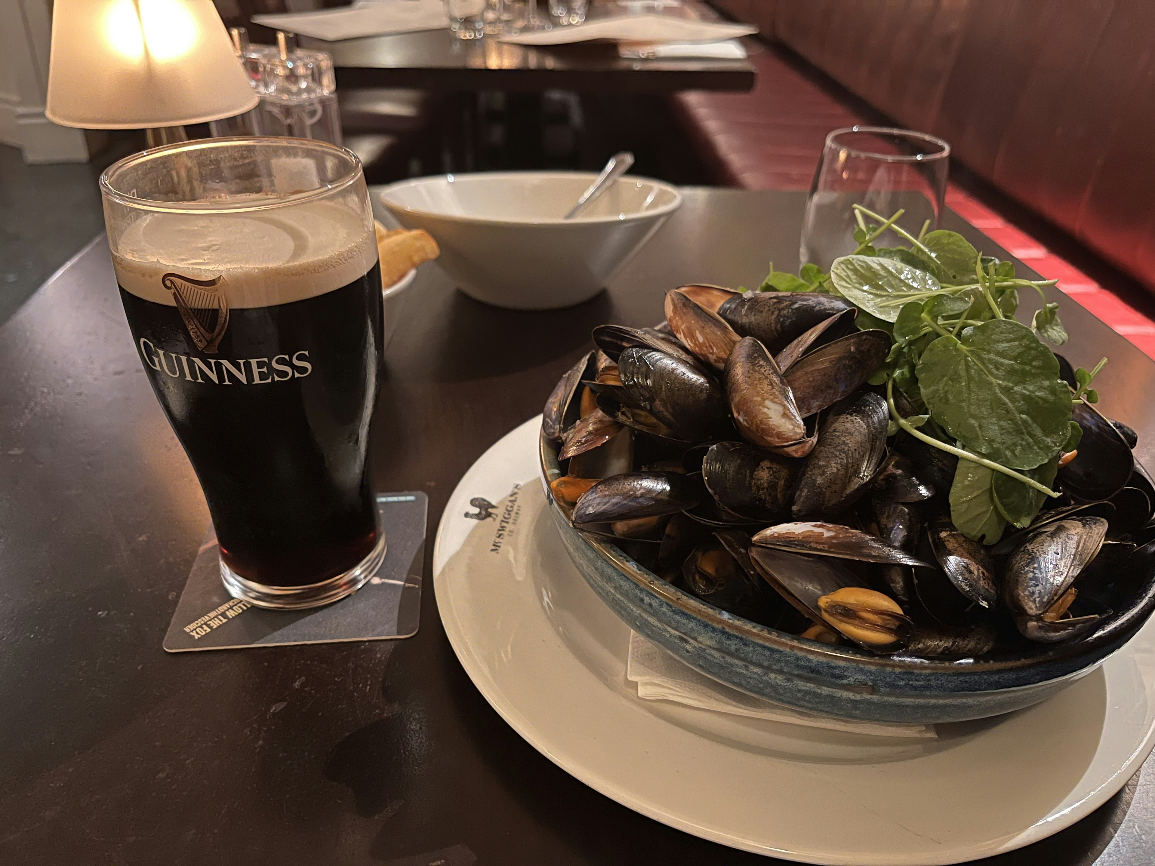 黒ビールとムール貝の皿のあるテーブルの風景