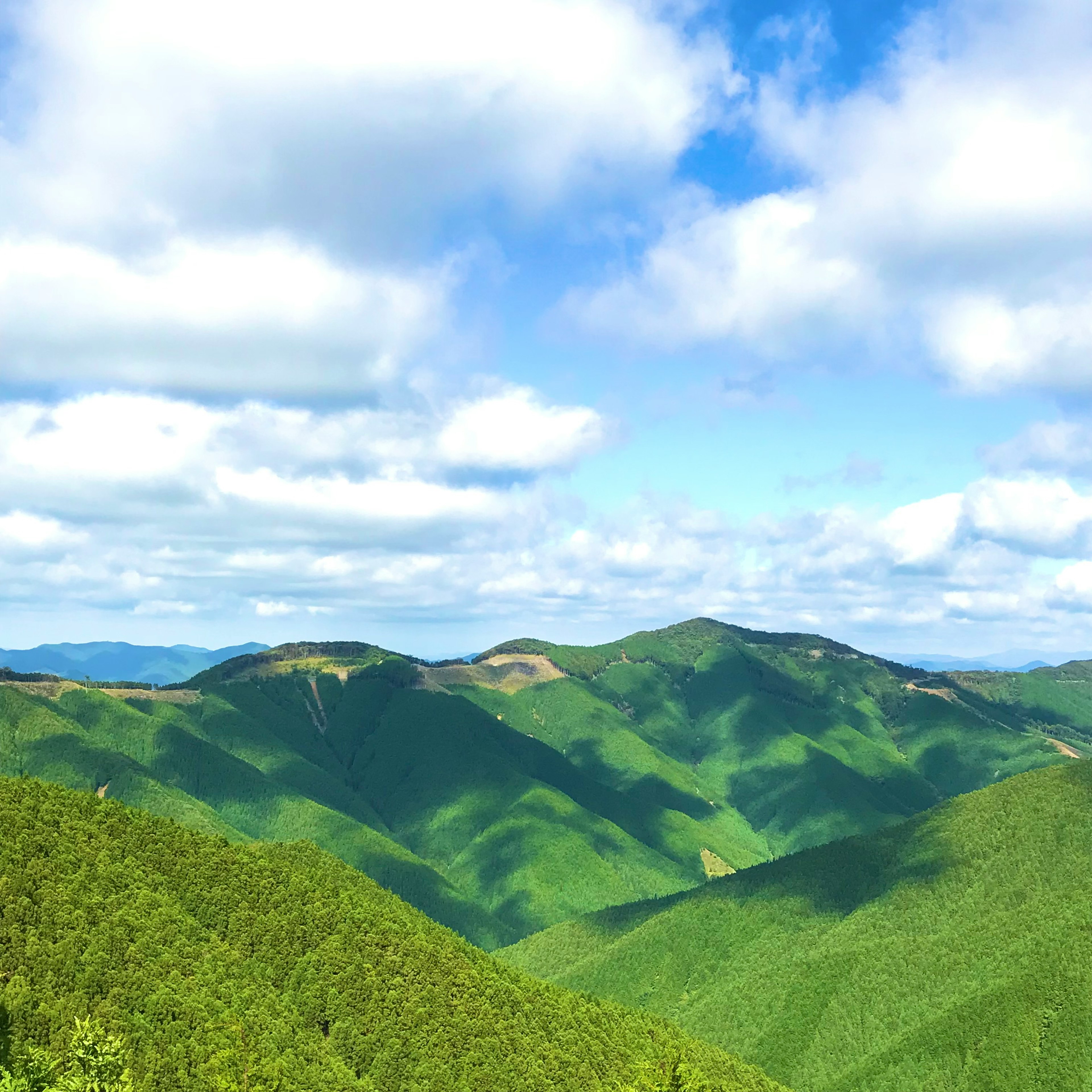 郁郁蔥蔥的綠色山脈和明亮的藍天