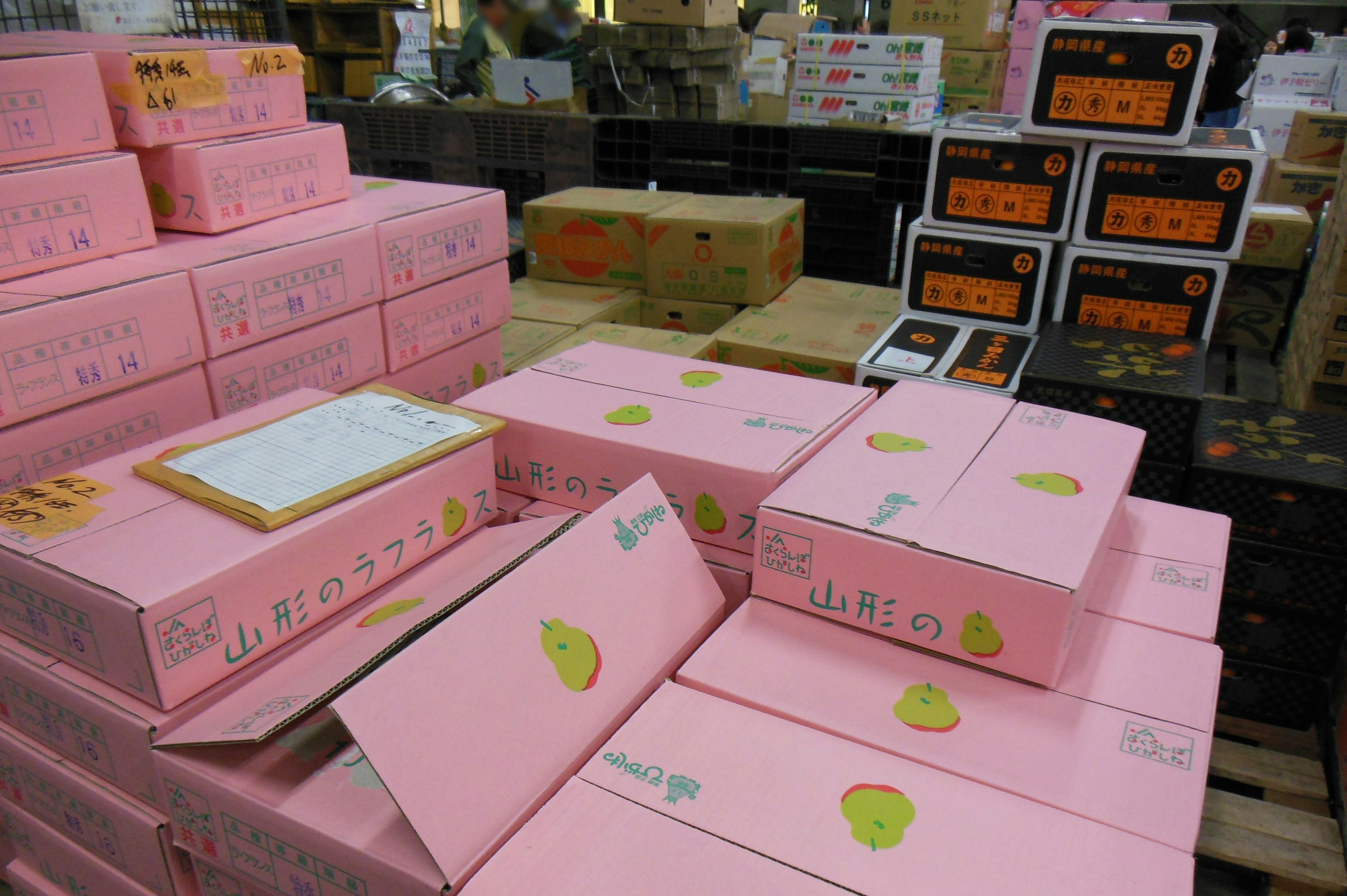 Piles of pink boxes with a background of orange boxes