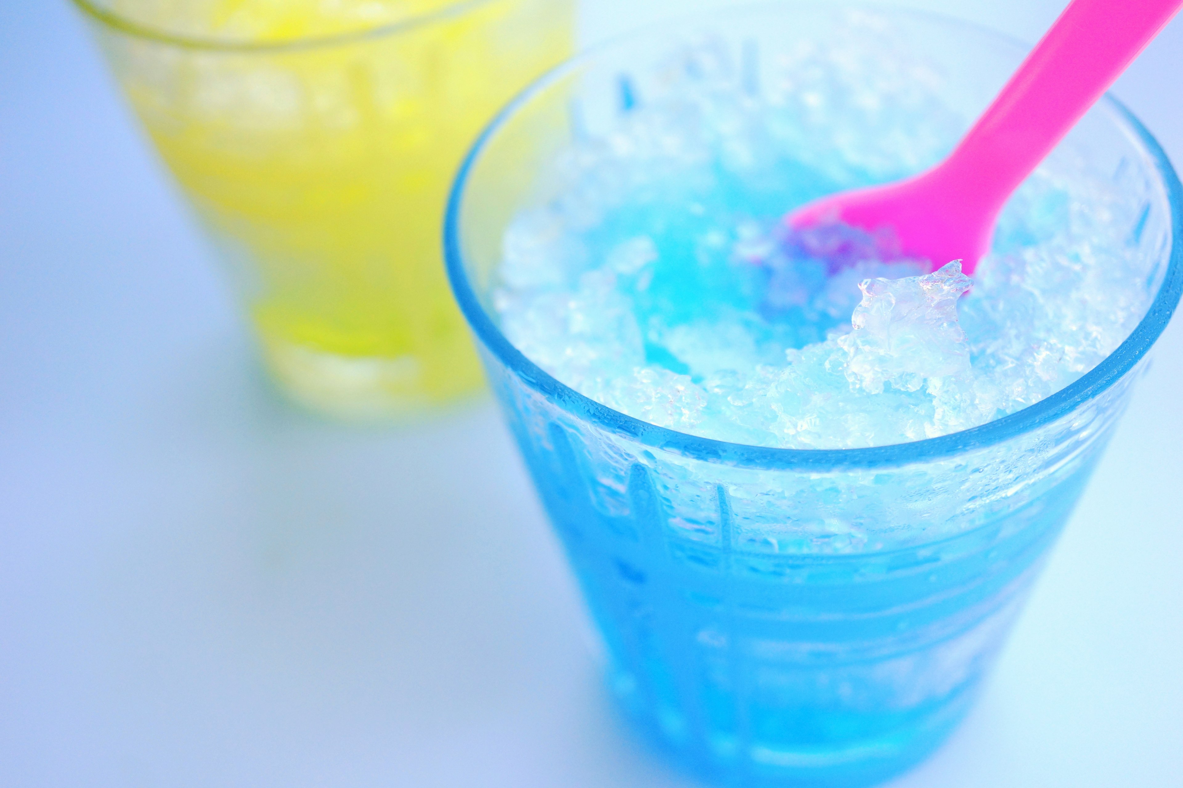 Image of blue icy drink and yellow drink in cups