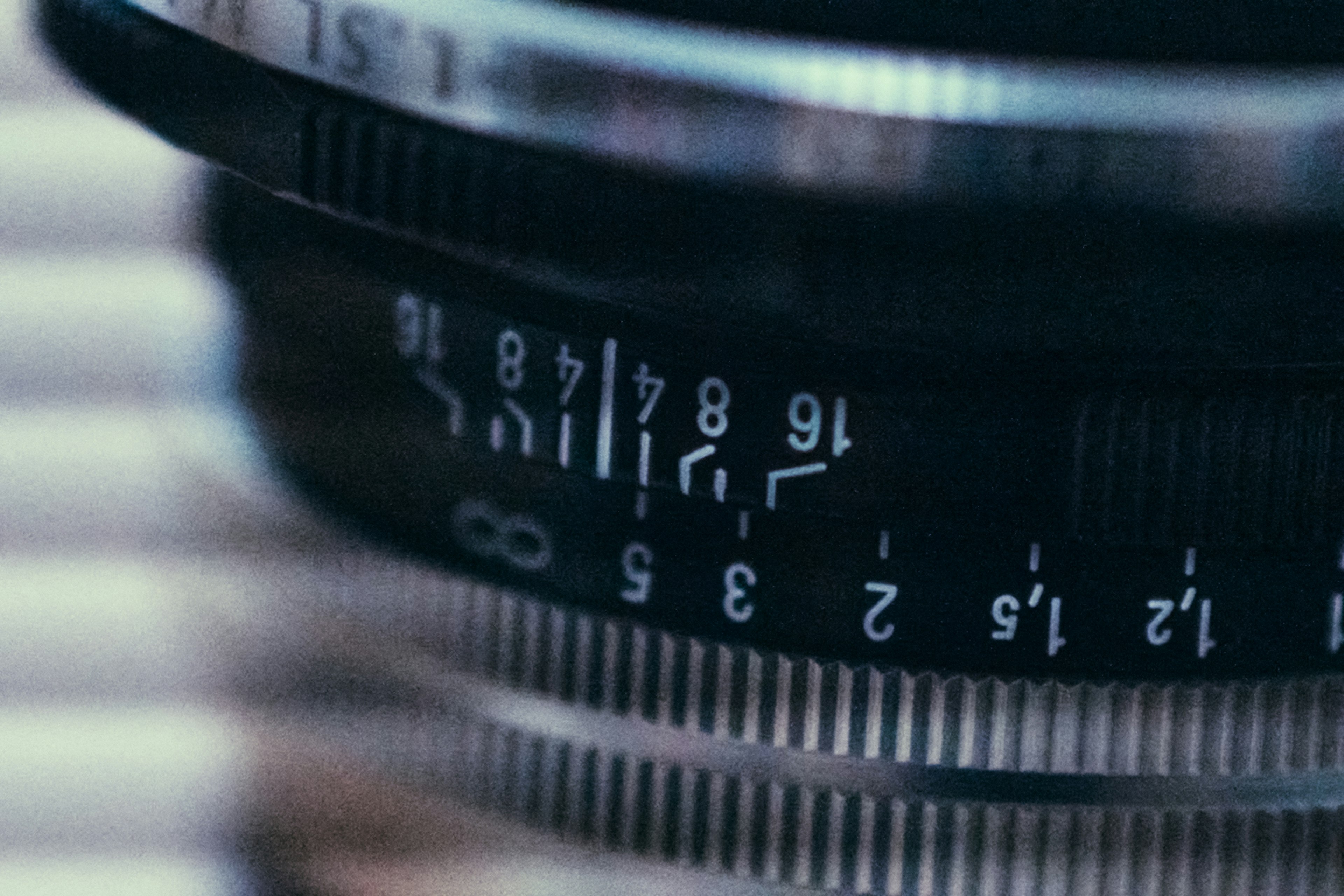 Close-up image of a camera lens showing focus distance and aperture markings