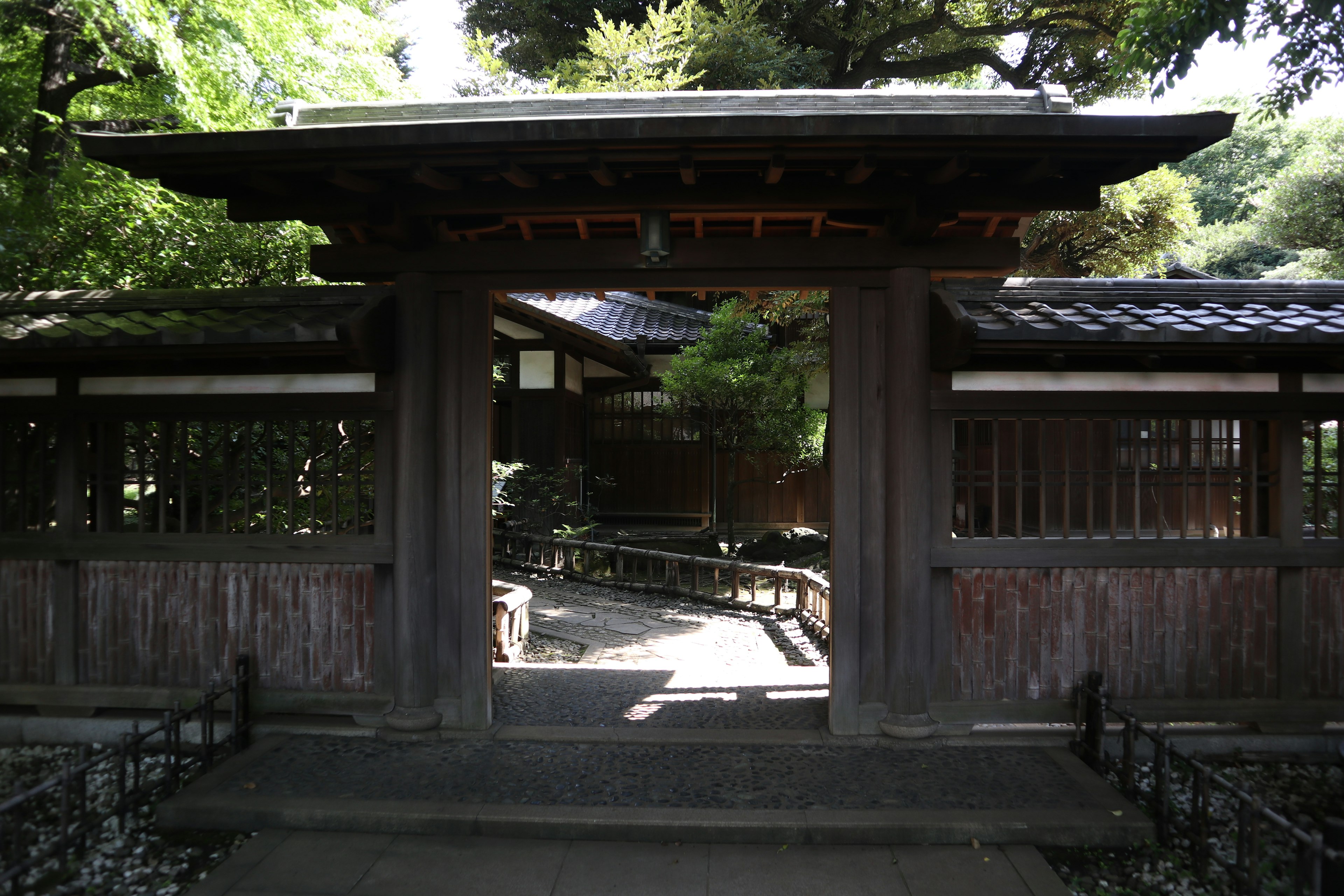 Traditional Japanese gate with a serene garden view