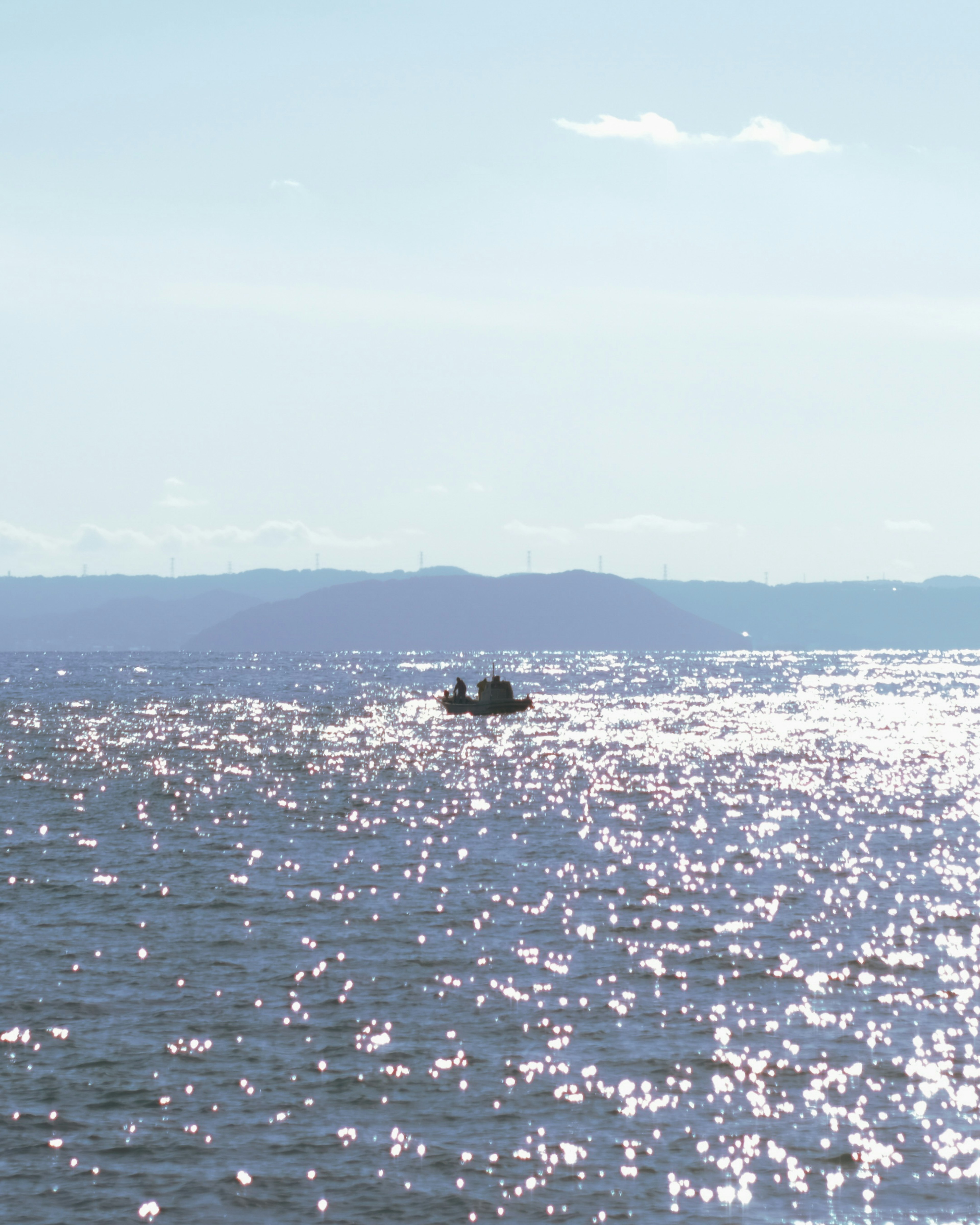 Scenic view of a boat on sparkling water under a clear sky