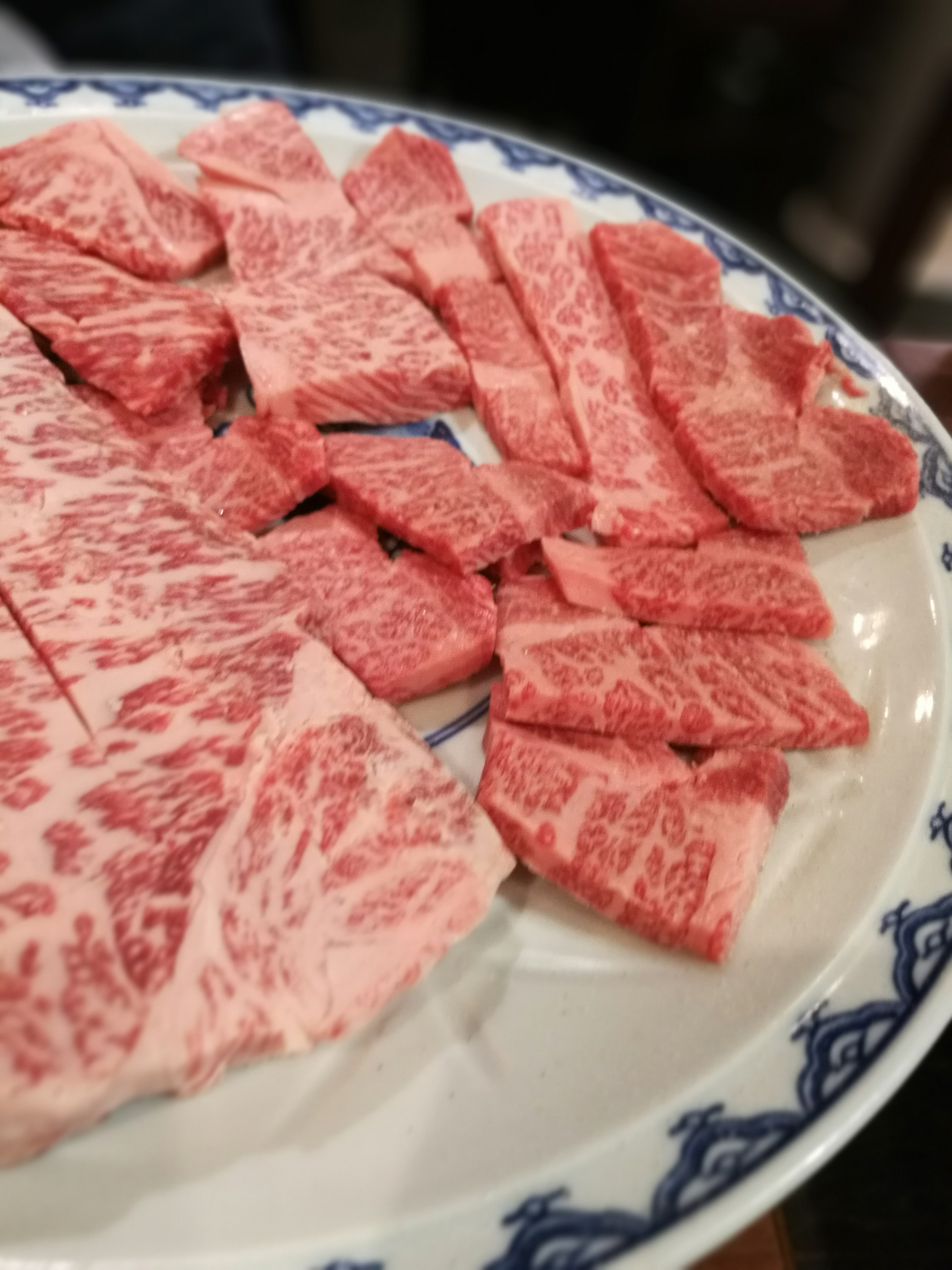 Beautifully marbled slices of wagyu beef arranged on a plate