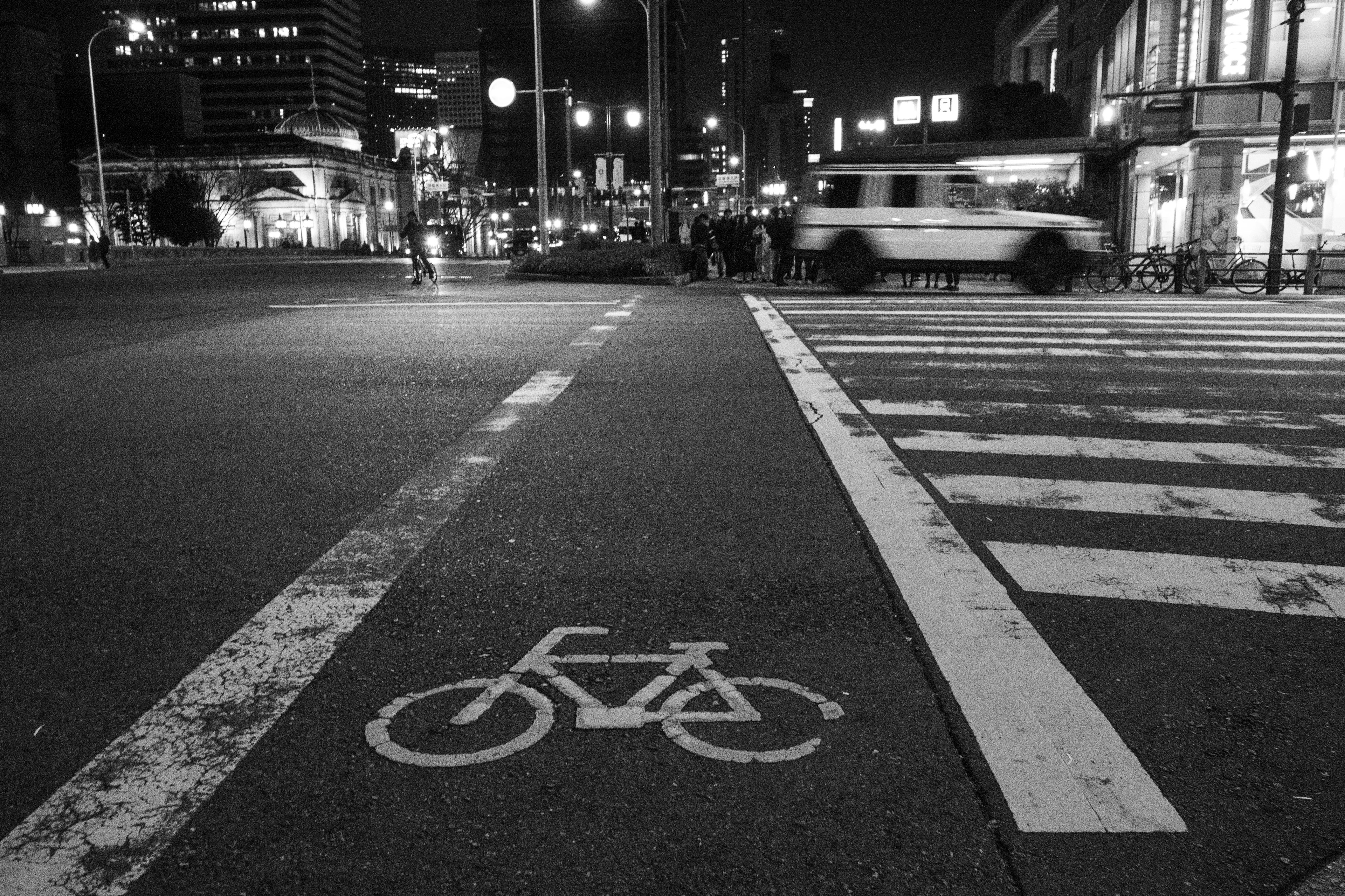 夜の街角の自転車レーンの標識と交差点の風景