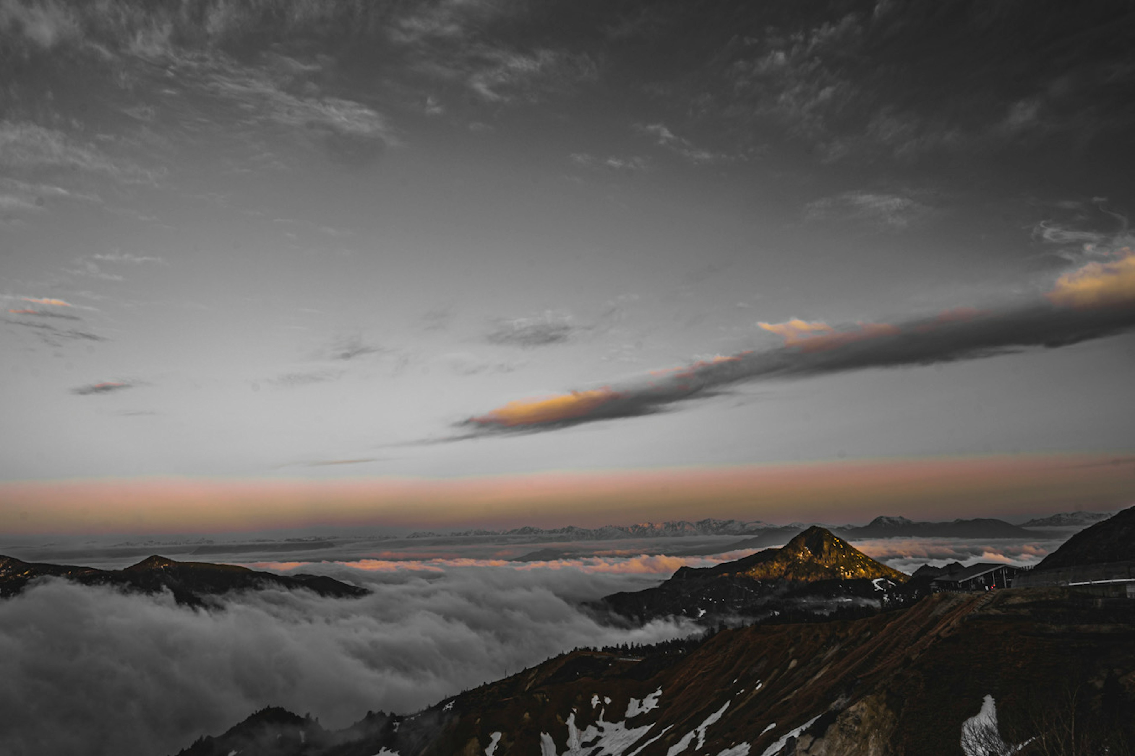 Mountain landscape covered in clouds with a dusk sky