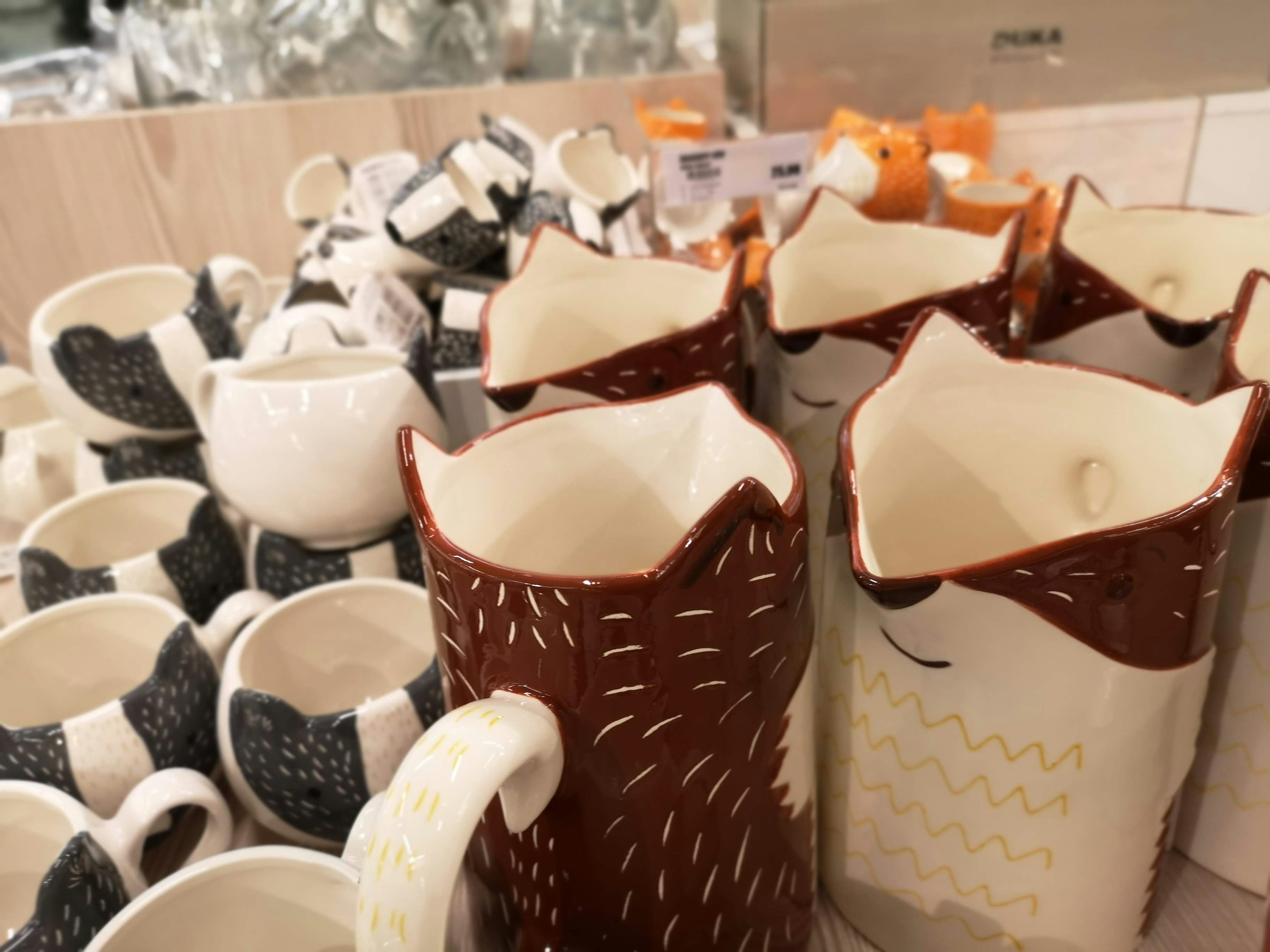 Colorful ceramic pitchers and cups arranged on a display