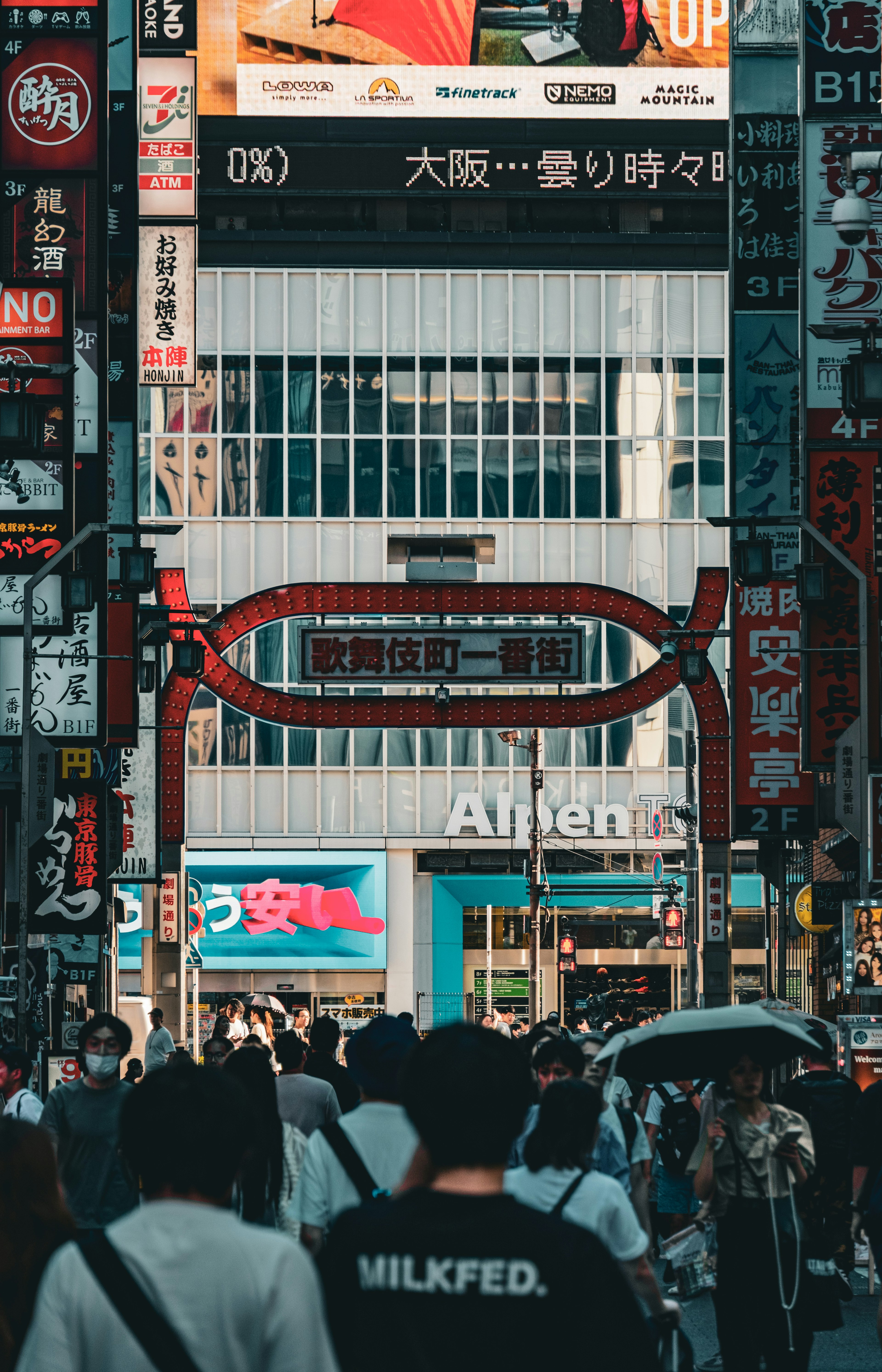 Archway entrance in Osaka's bustling streets with crowds of people