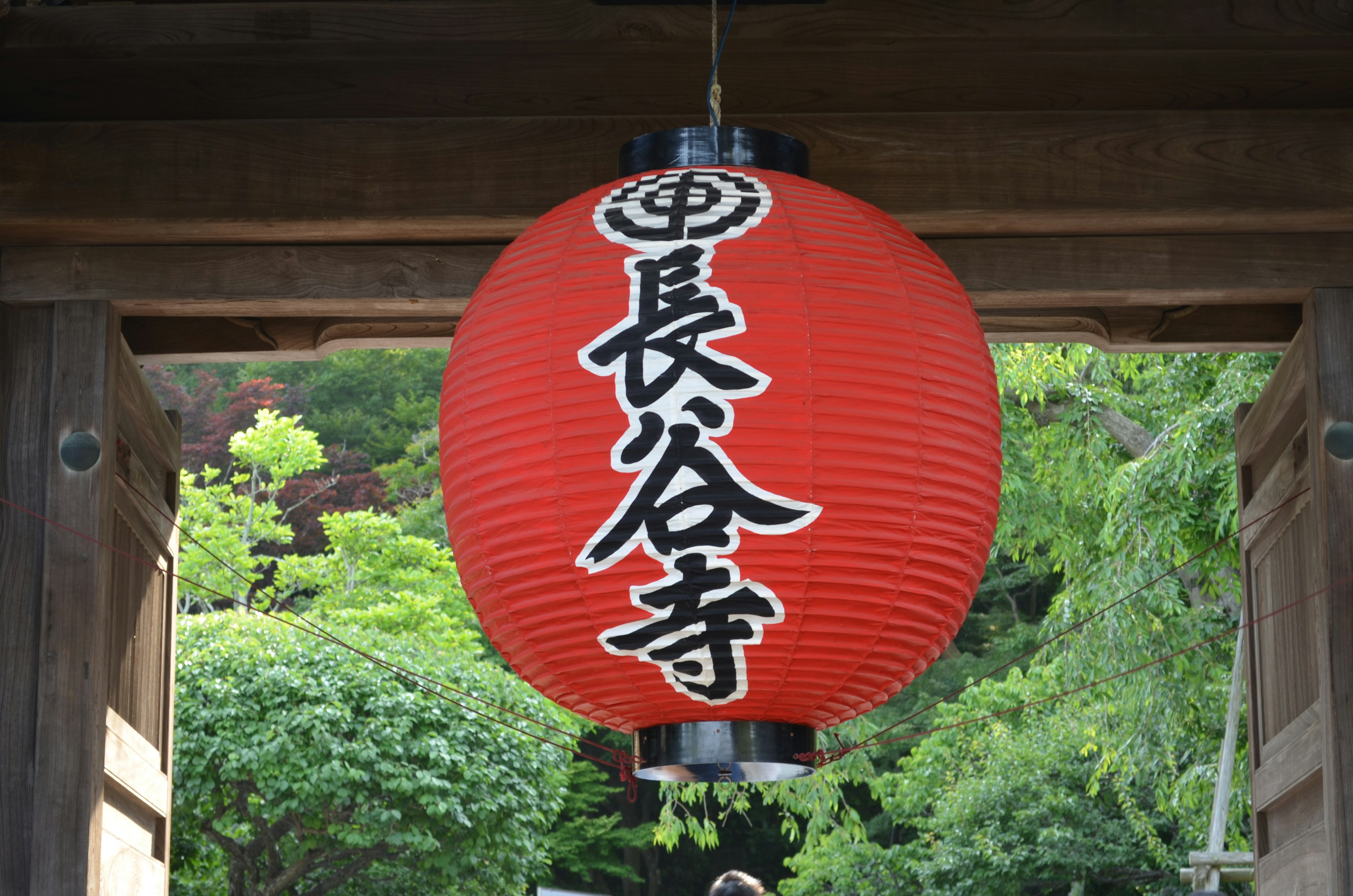 Une lanterne rouge avec les caractères du temple Hase-dera