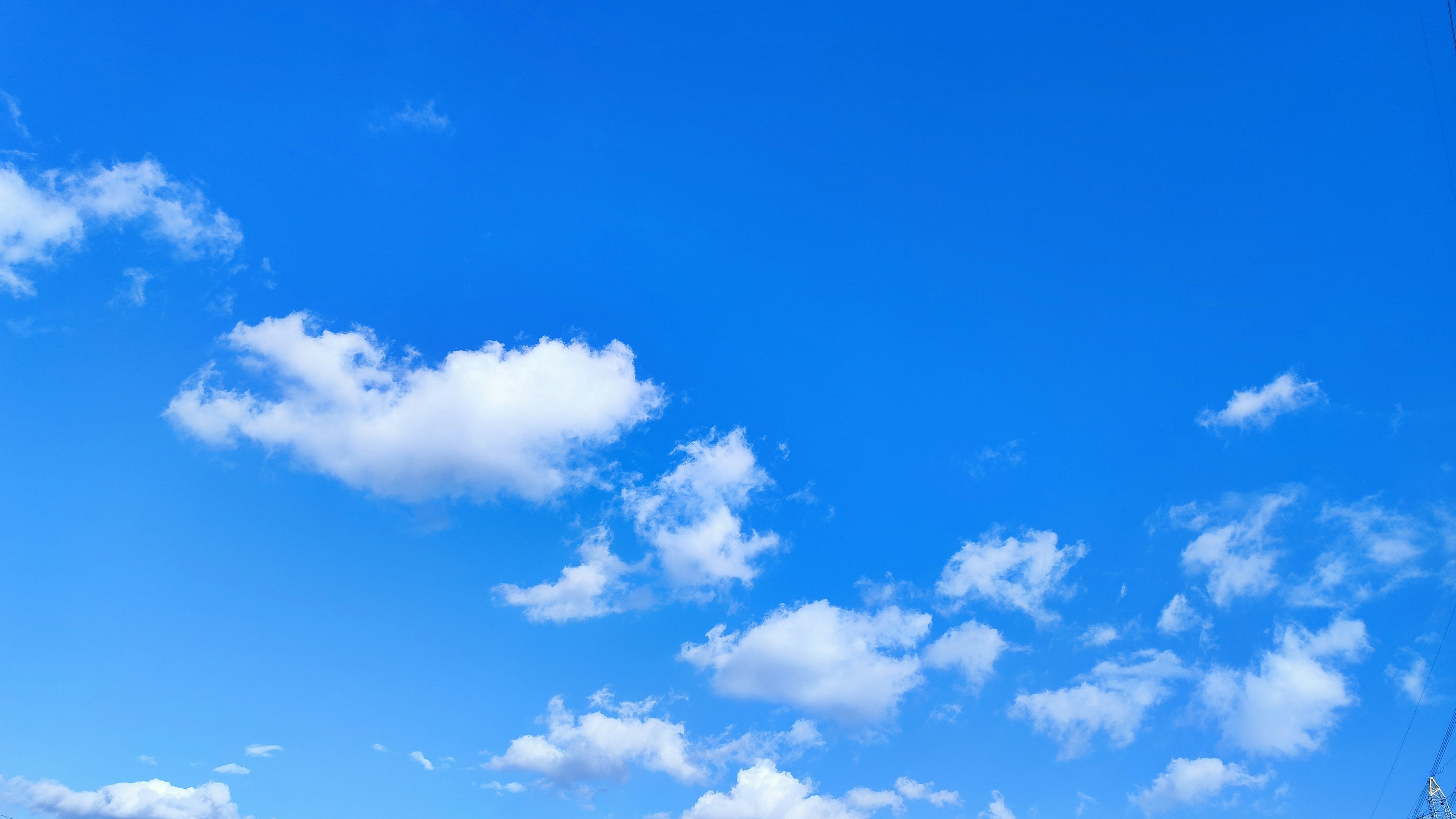 Clear blue sky with fluffy white clouds