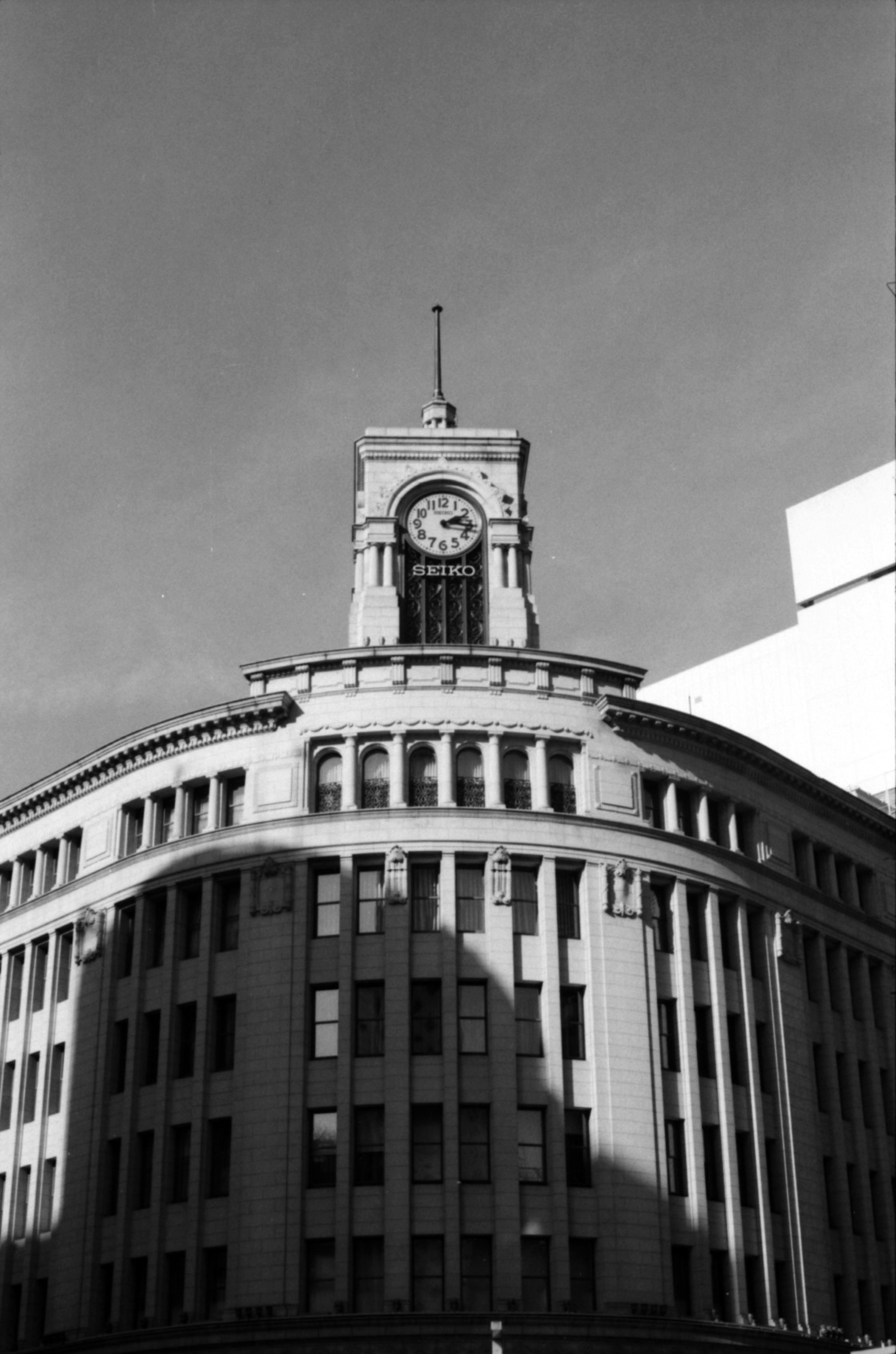 Black and white photo of a modern building with a clock tower