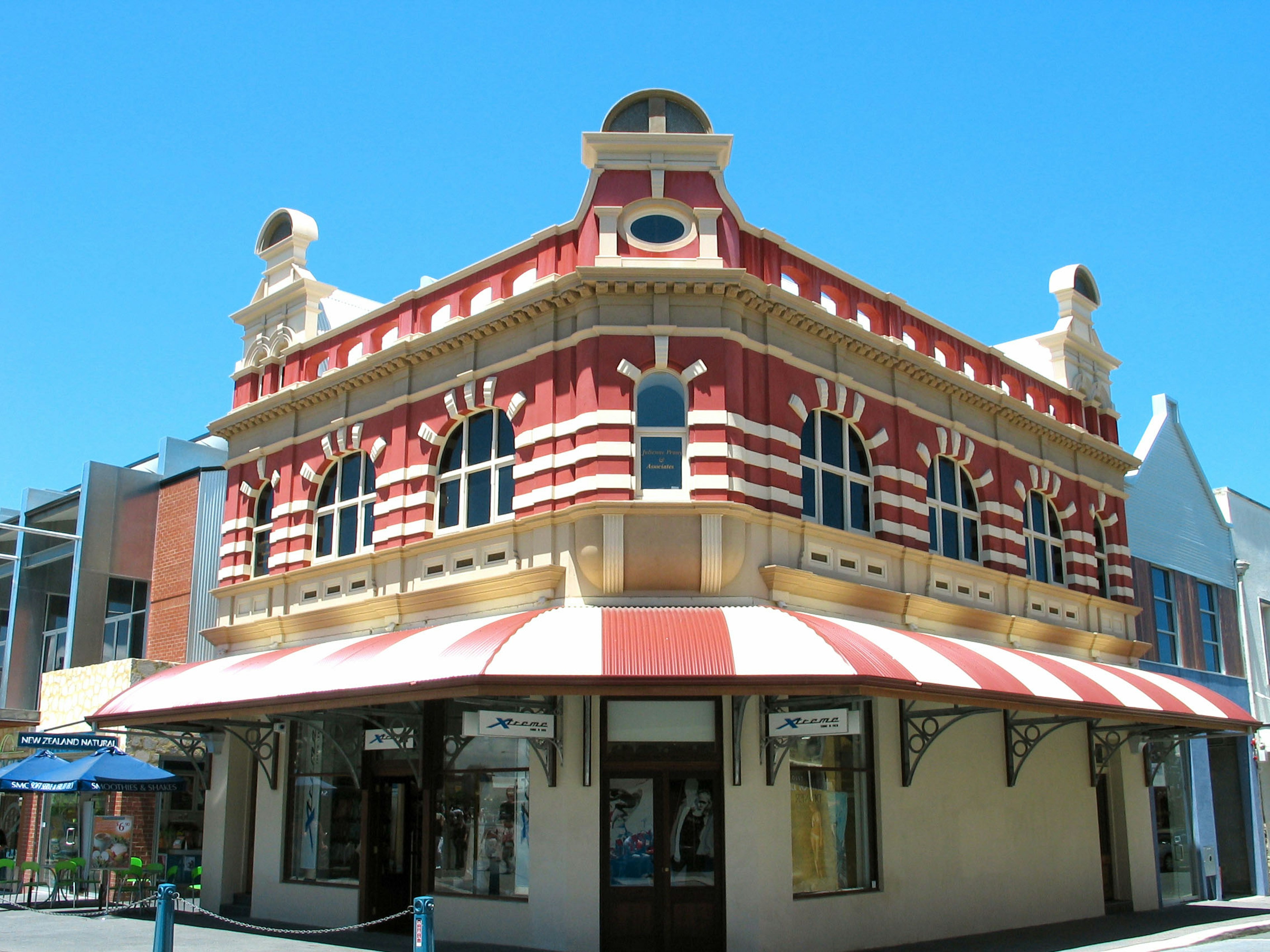 Historic building with red and white striped awning and unique architectural details