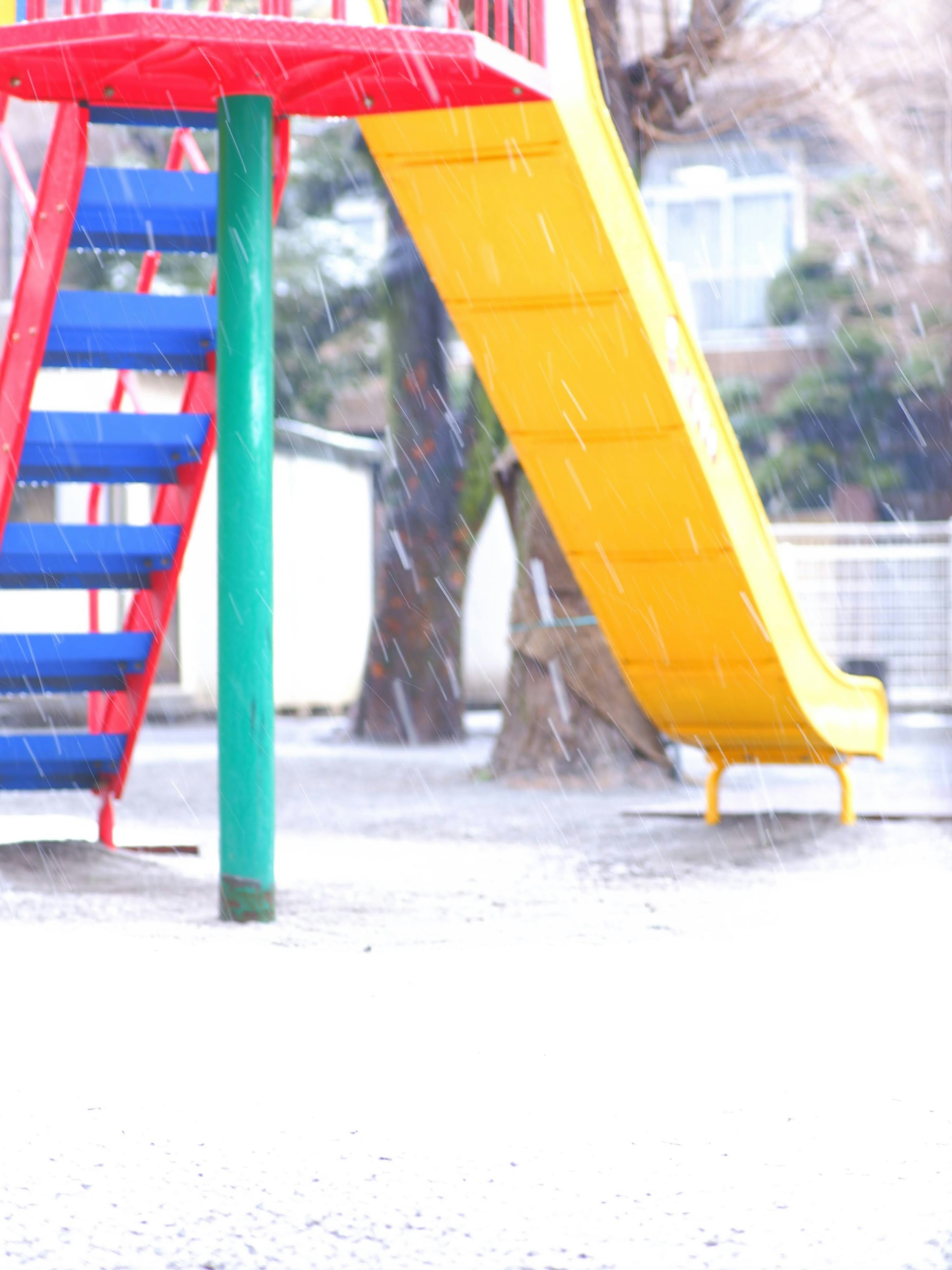 Colorful playground slide and stairs in the snow